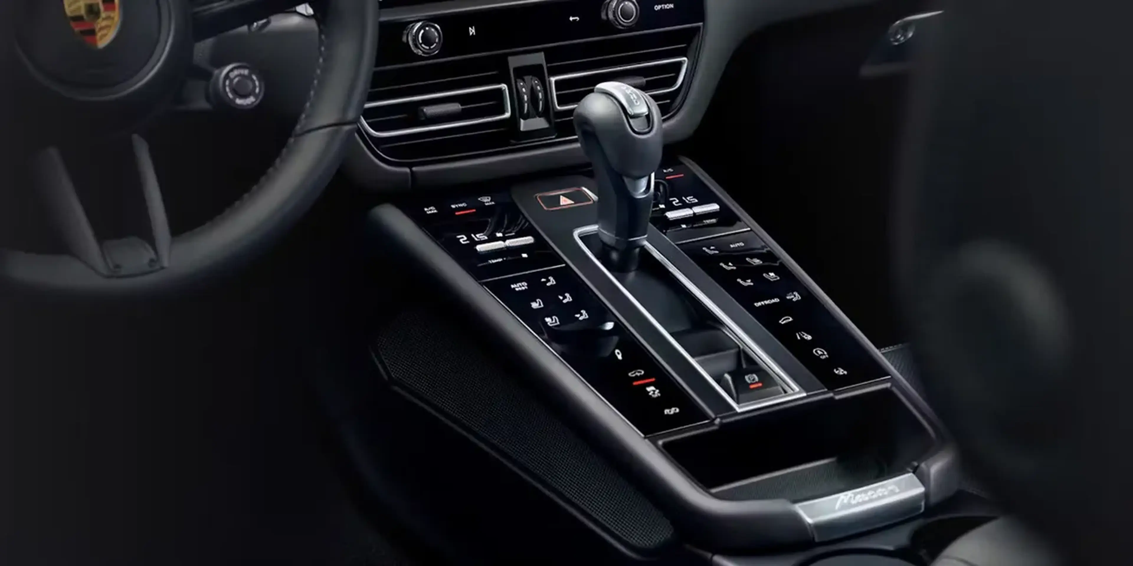 Close-up of Porsche Macan T center console showing gear shifter and control buttons