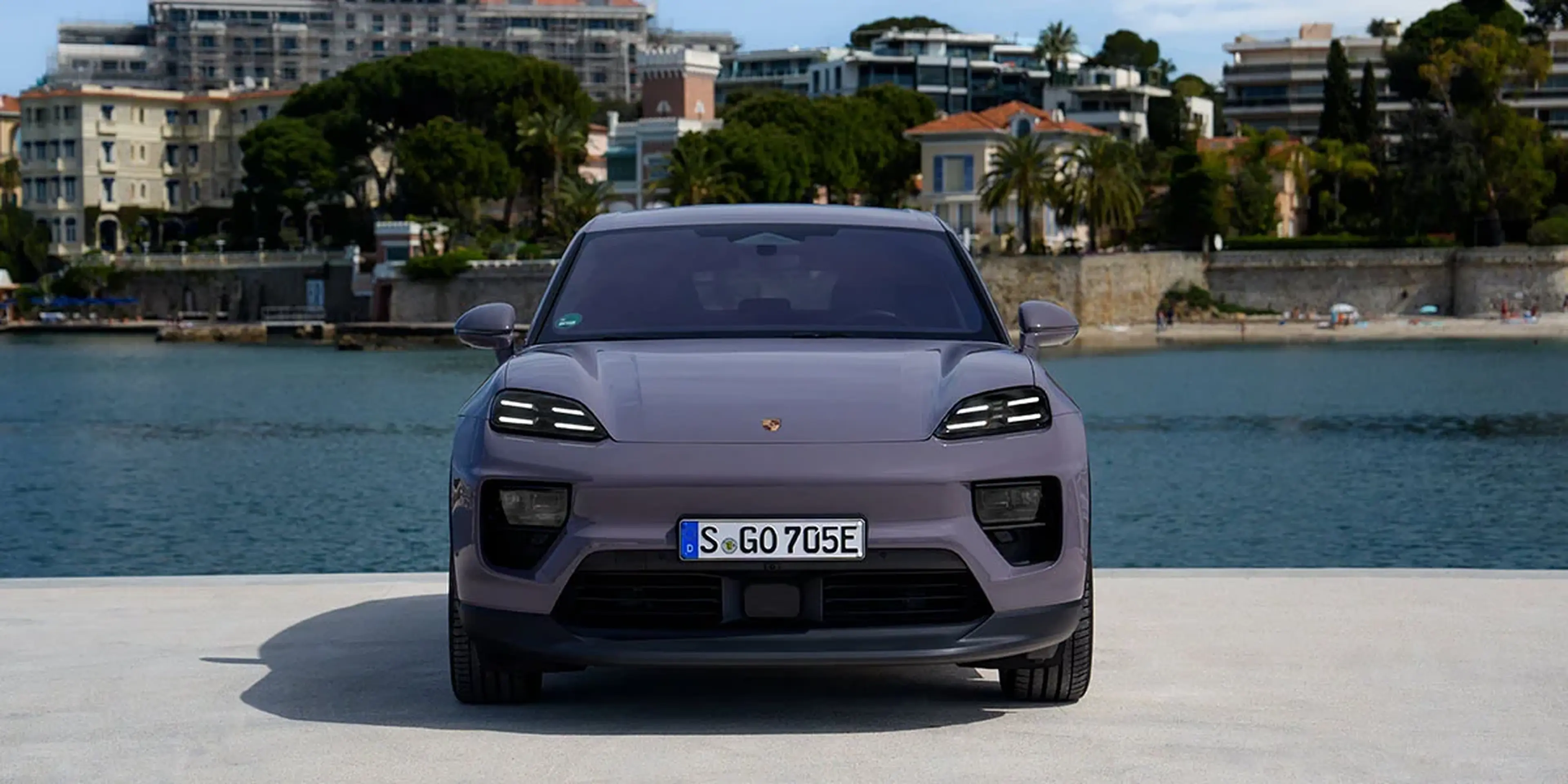 2025 Porsche Macan 4 Electric front view in a coastal town