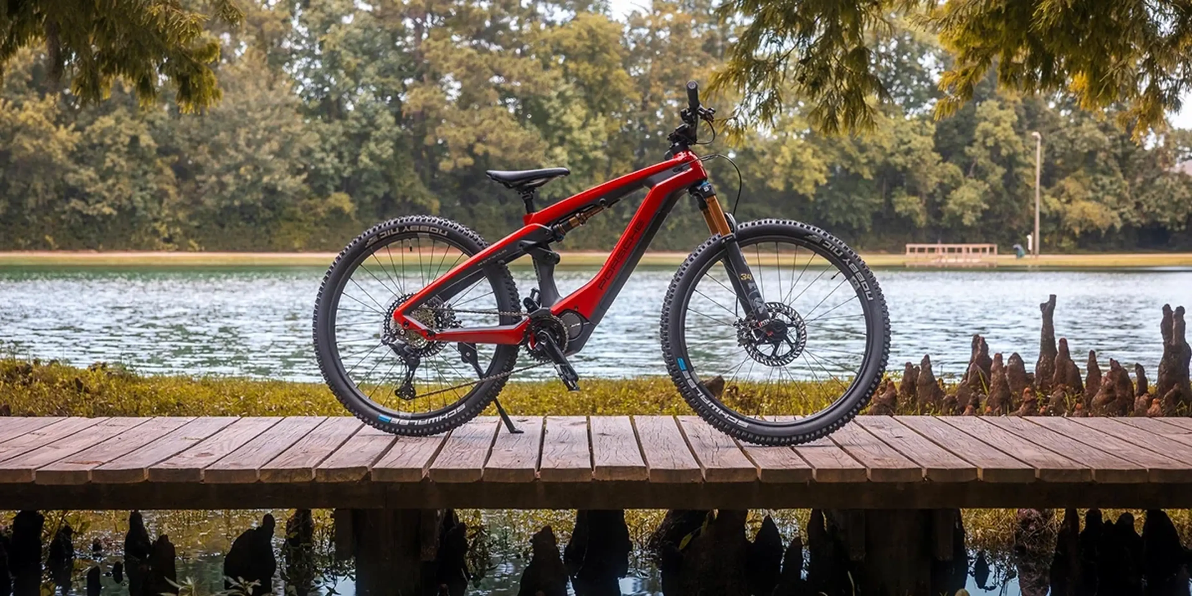 Red Porsche eBike on a waterfront boardwalk