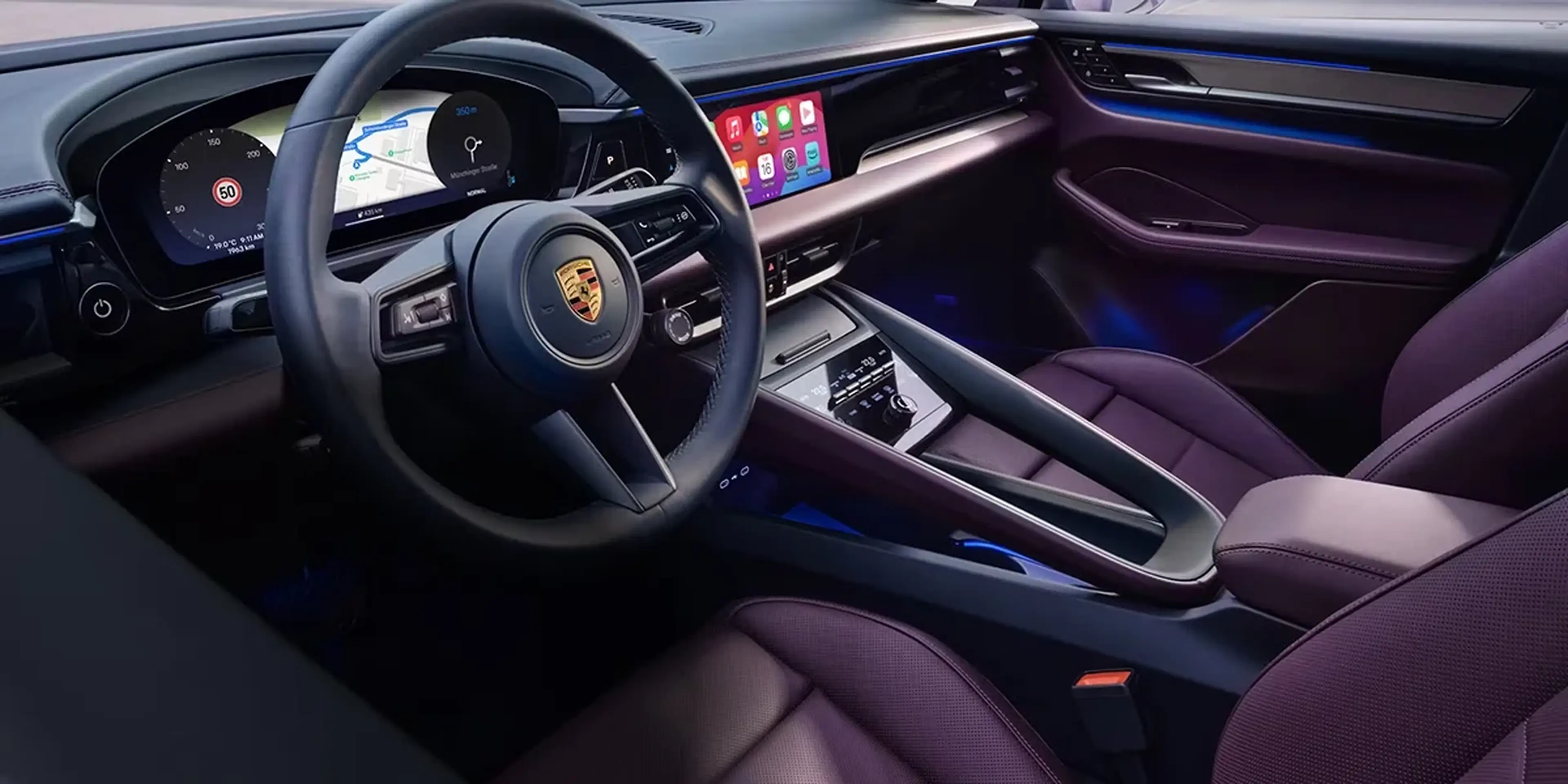 Three-quarter rear view of Porsche Macan T in a dark studio environment