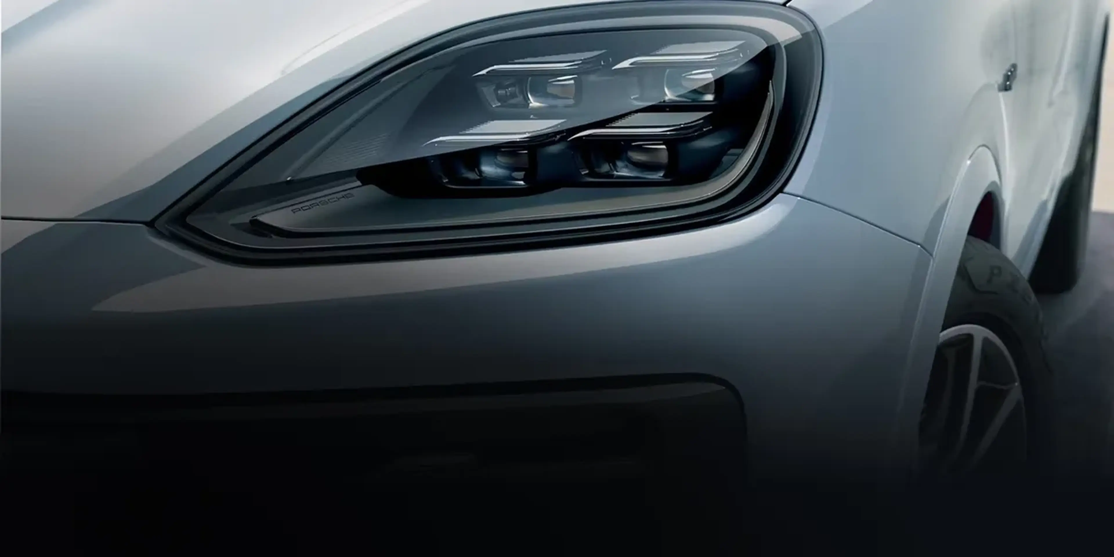 Close-up of the 2026 Porsche Cayenne front wheel with black alloy rim and performance-tuned suspension.