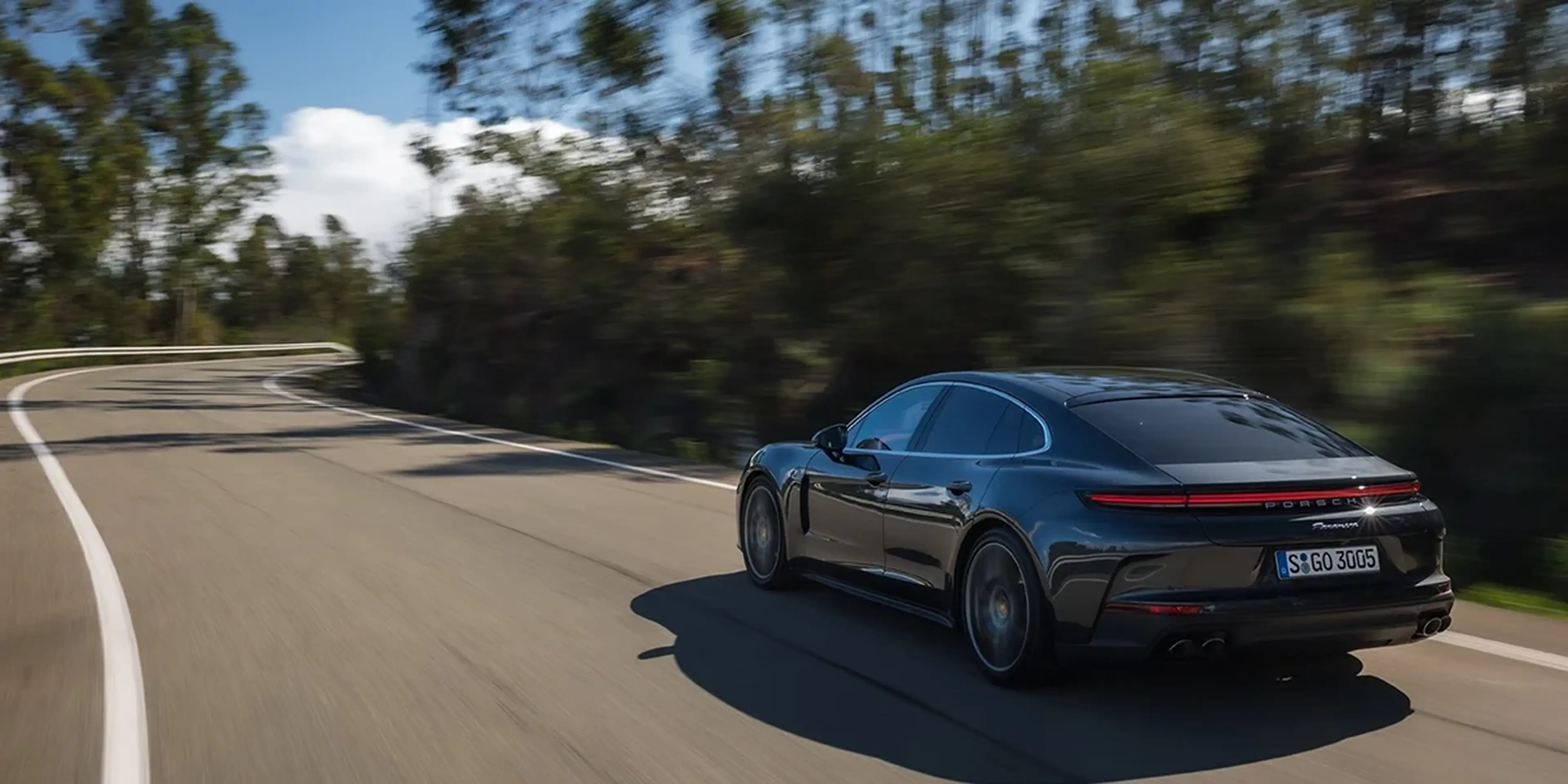 2025 Porsche Panamera driving on a forest road