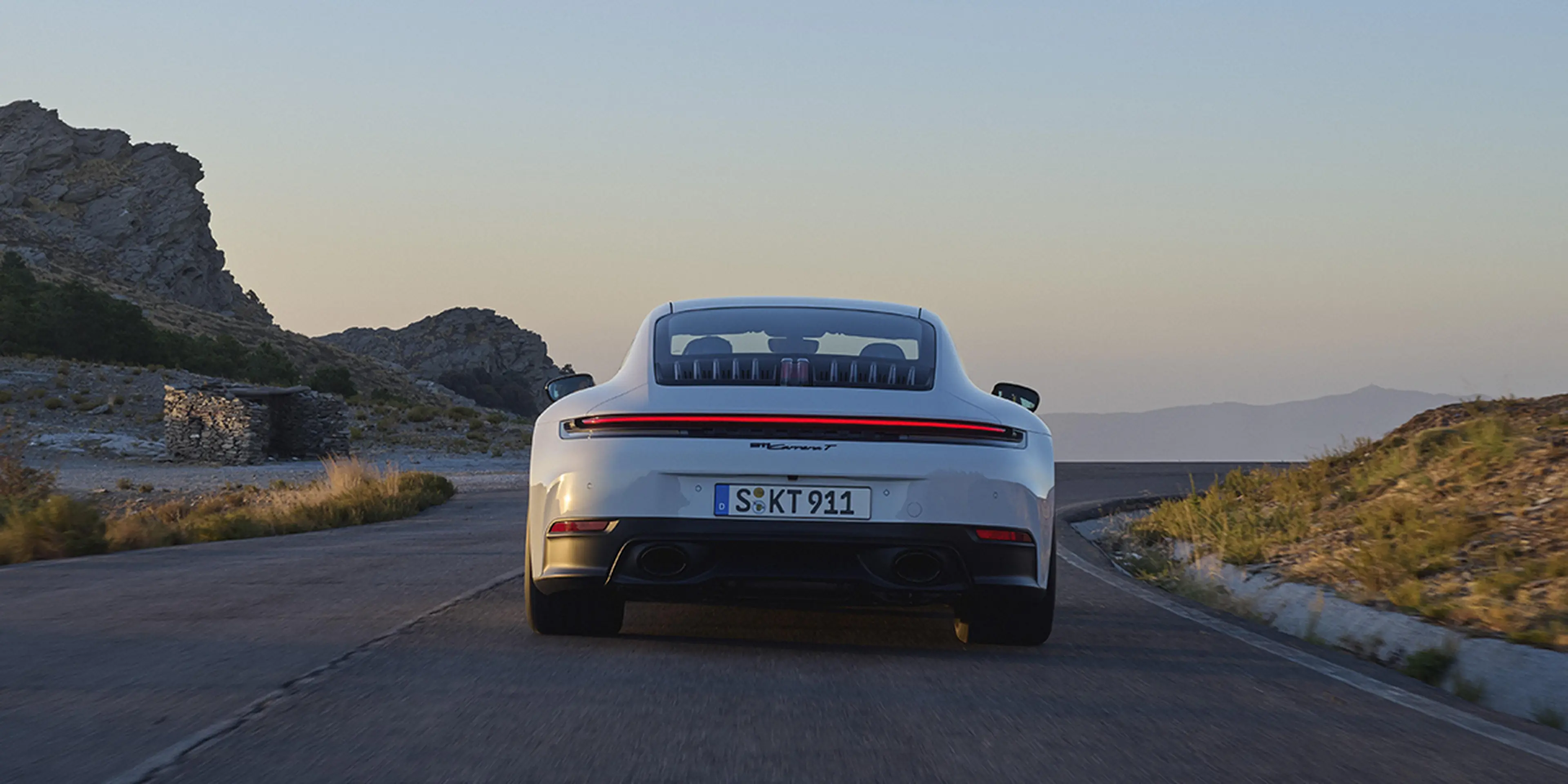2025 Porsche 911 Carrera T rear view at sunset