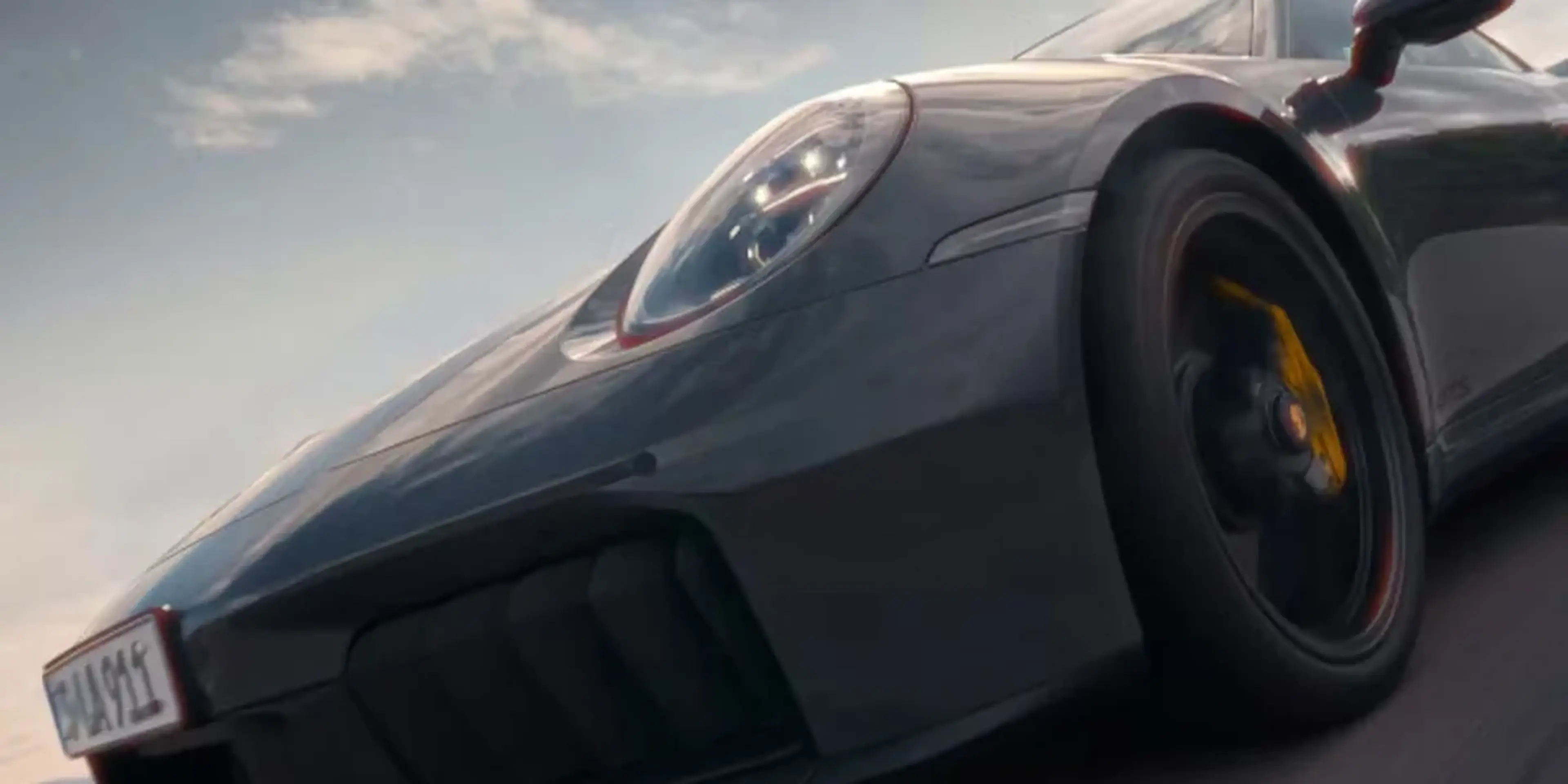 Close-up of Porsche 911 Carrera 4S wheel and carbon-ceramic brakes, representing all-wheel-drive stability and braking control.