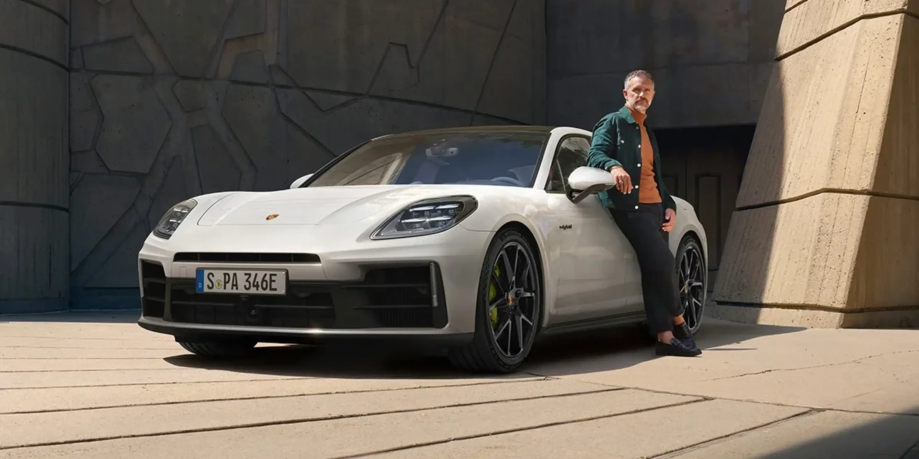 Porsche Panamera 4 E-Hybrid luxury plug-in hybrid sedan parked with modern architectural background.