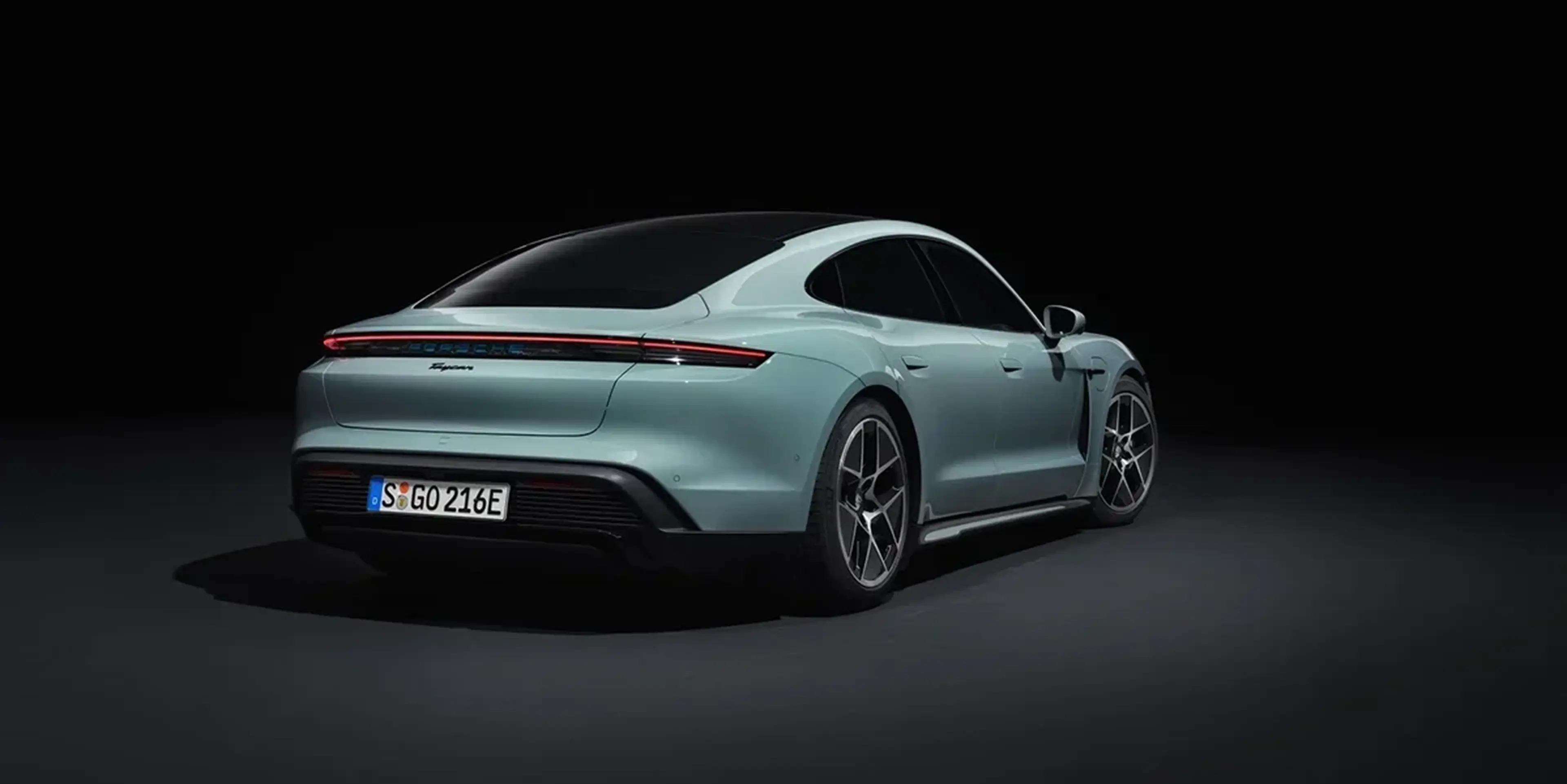 Mint green 2025 Porsche Taycan front three-quarter view
