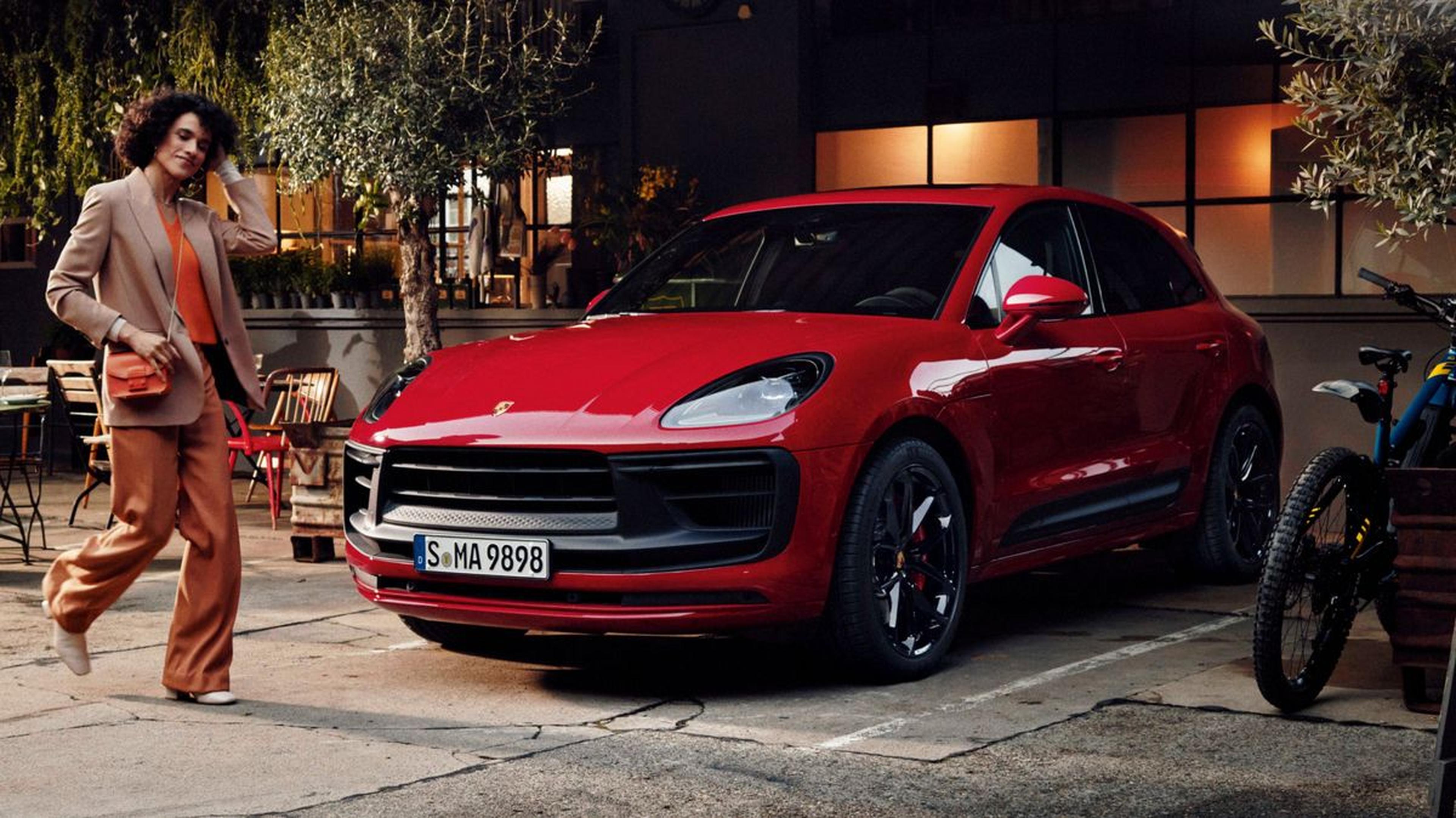 2026 Porsche Macan GTS in Carmine Red parked outside a brick building