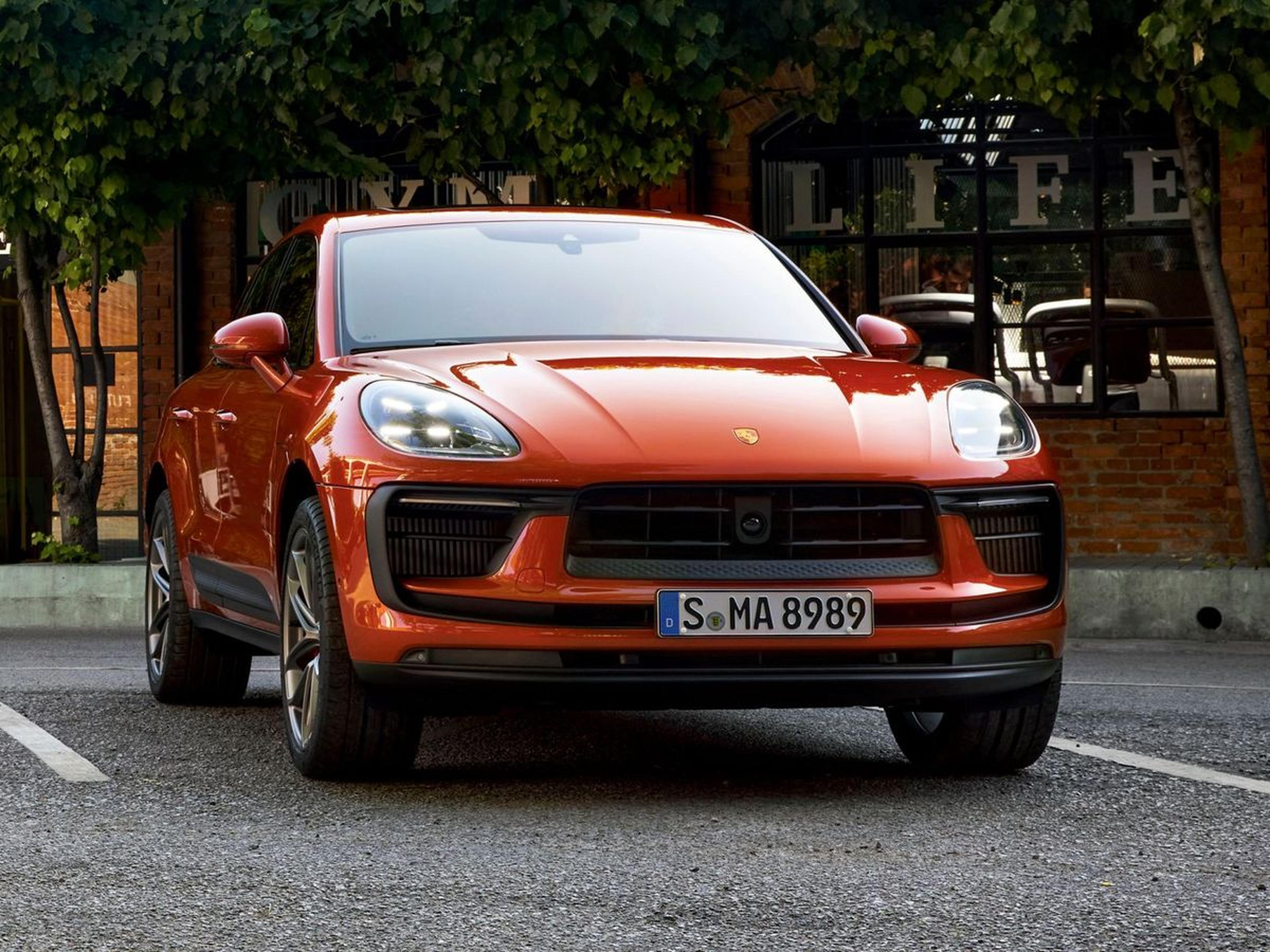 2026 Porsche Macan S in Papaya Metallic parked on a city street