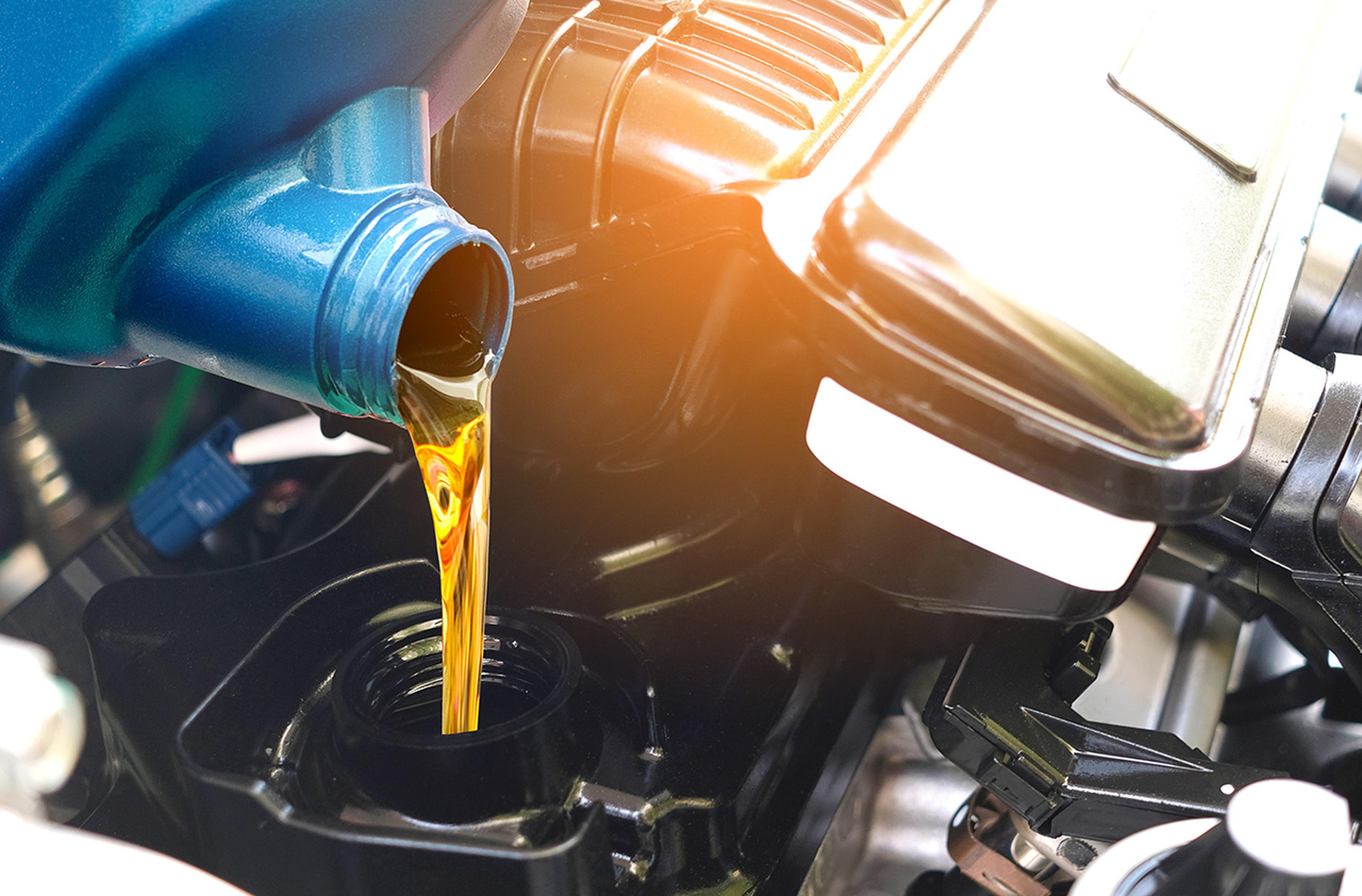 Technician performing Porsche oil change