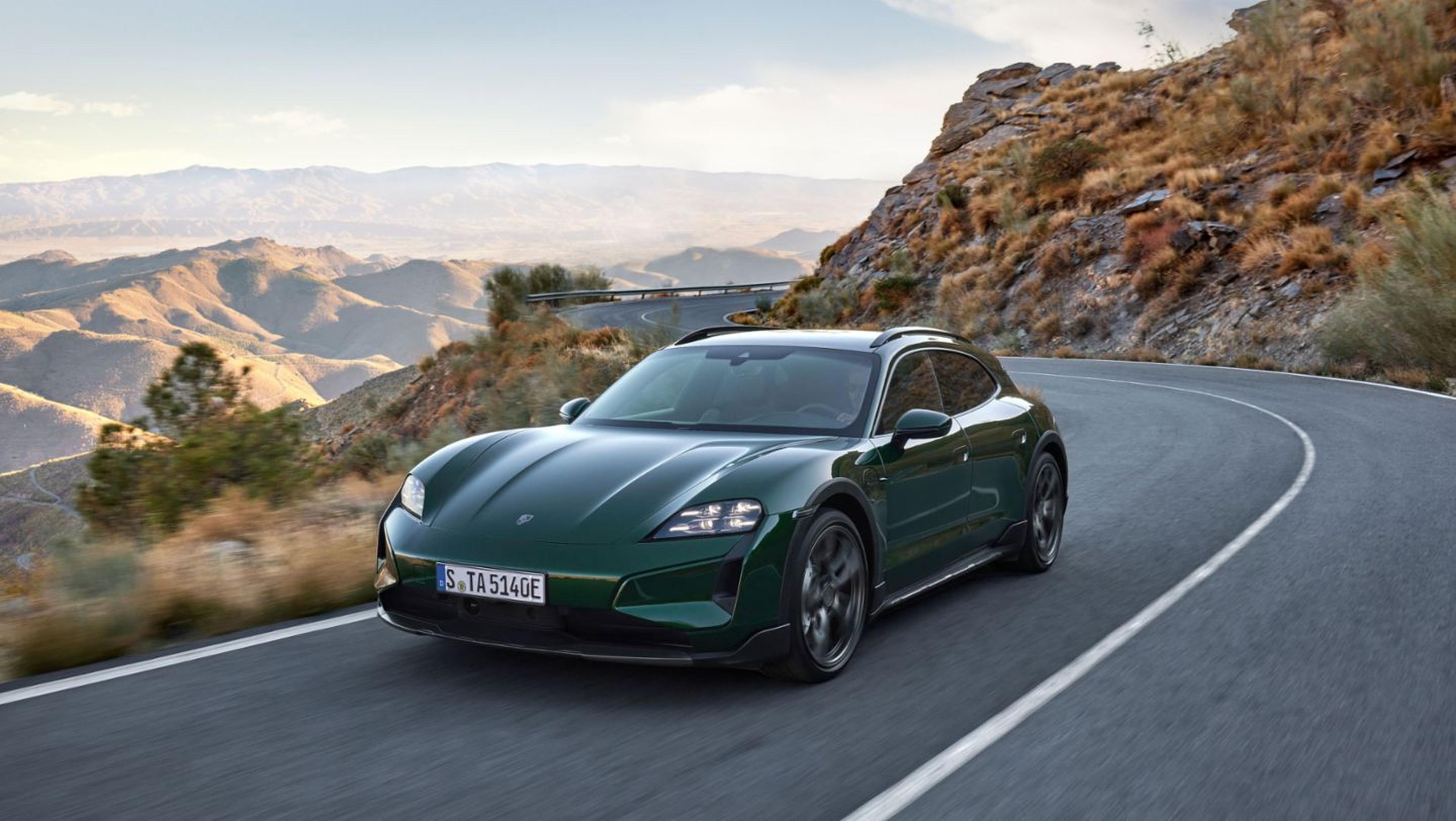 2025 Porsche Taycan Turbo GT in Oak Green Metallic Neo driving on highway through desert mountains.