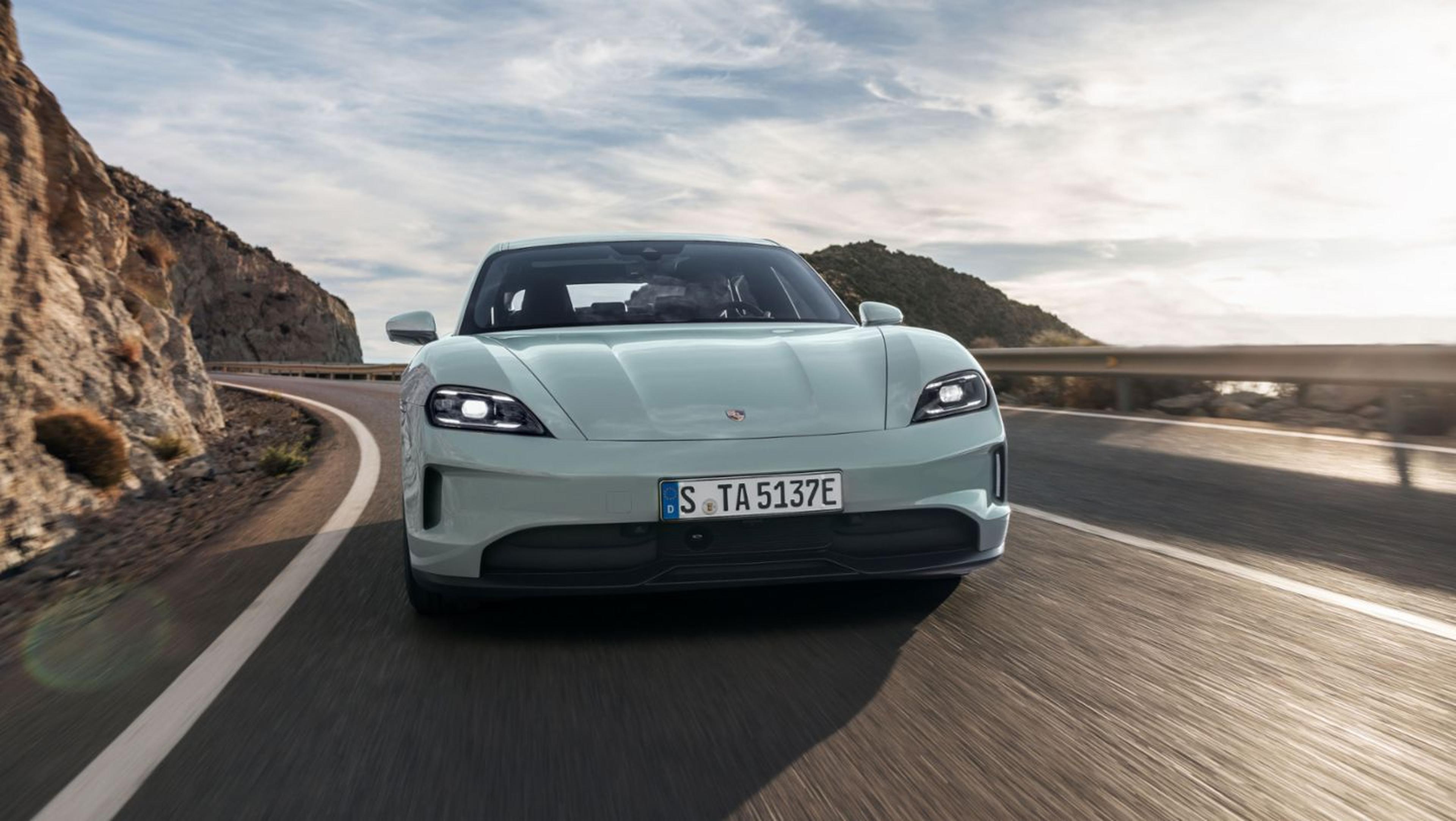 2025 Porsche Taycan Turbo in Shade Green Metallic driving on coastal highway.