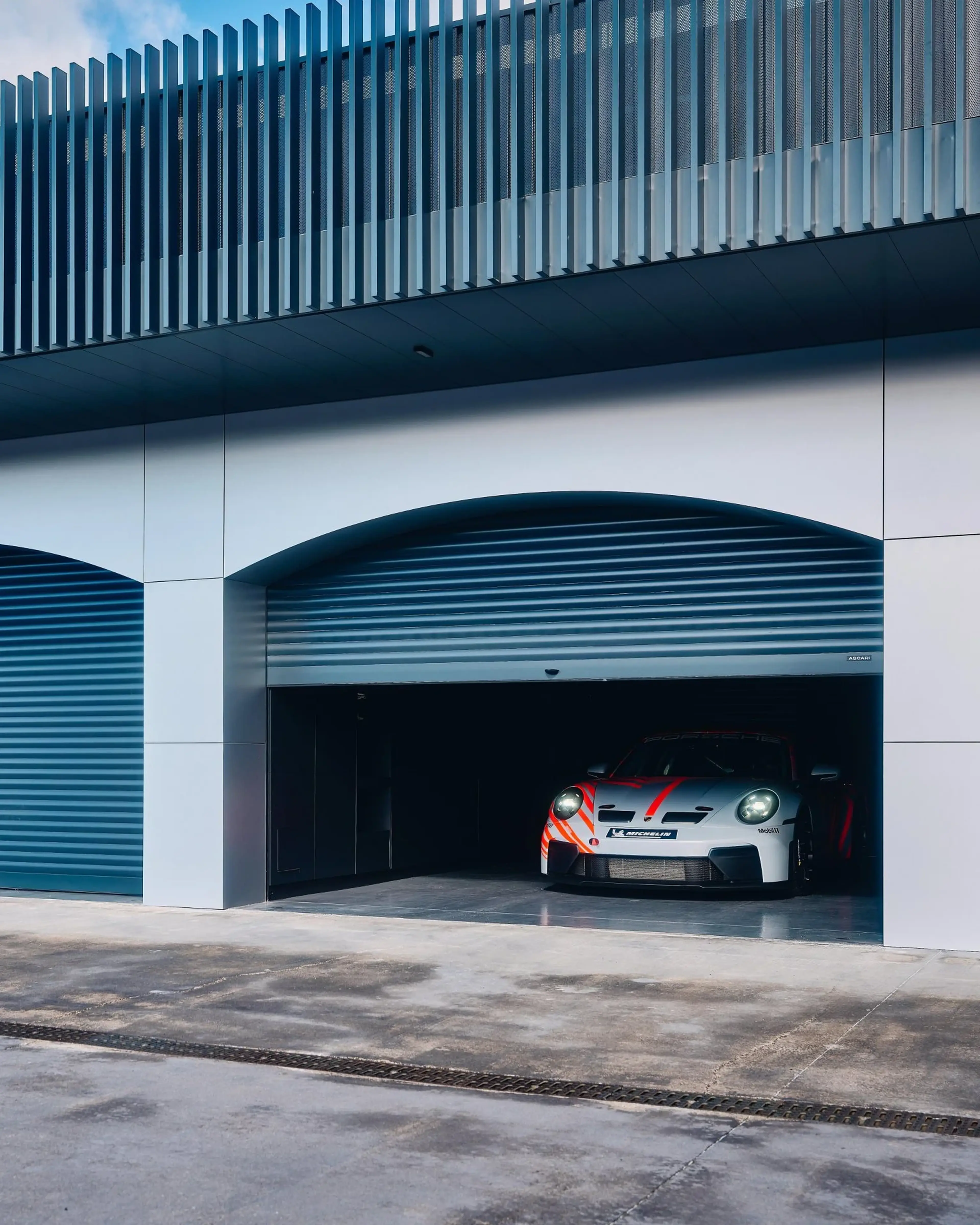 Porsche race car in the pit garage