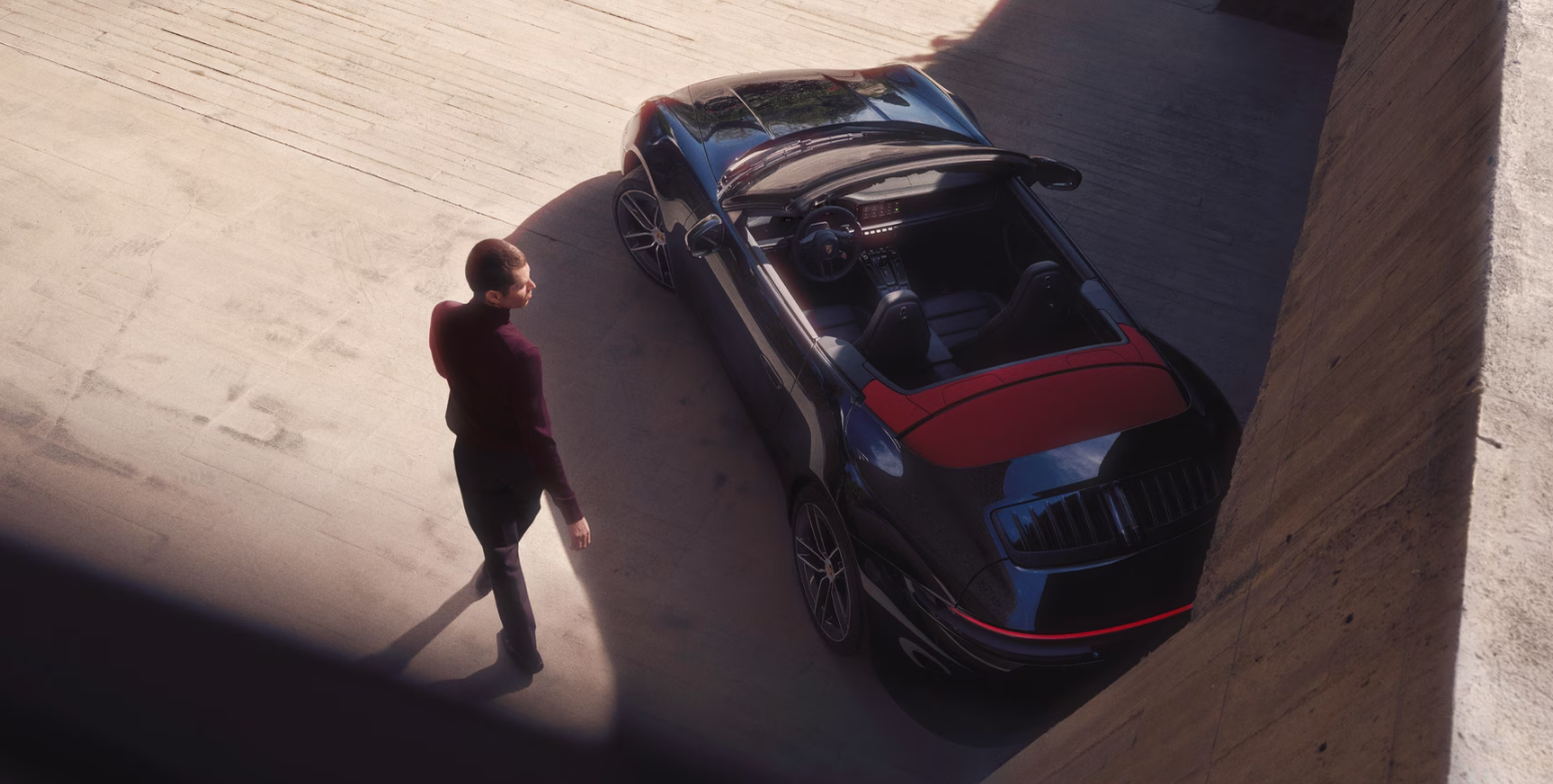 Man entering a 2027 Porsche 911 Carrera Cabriolet