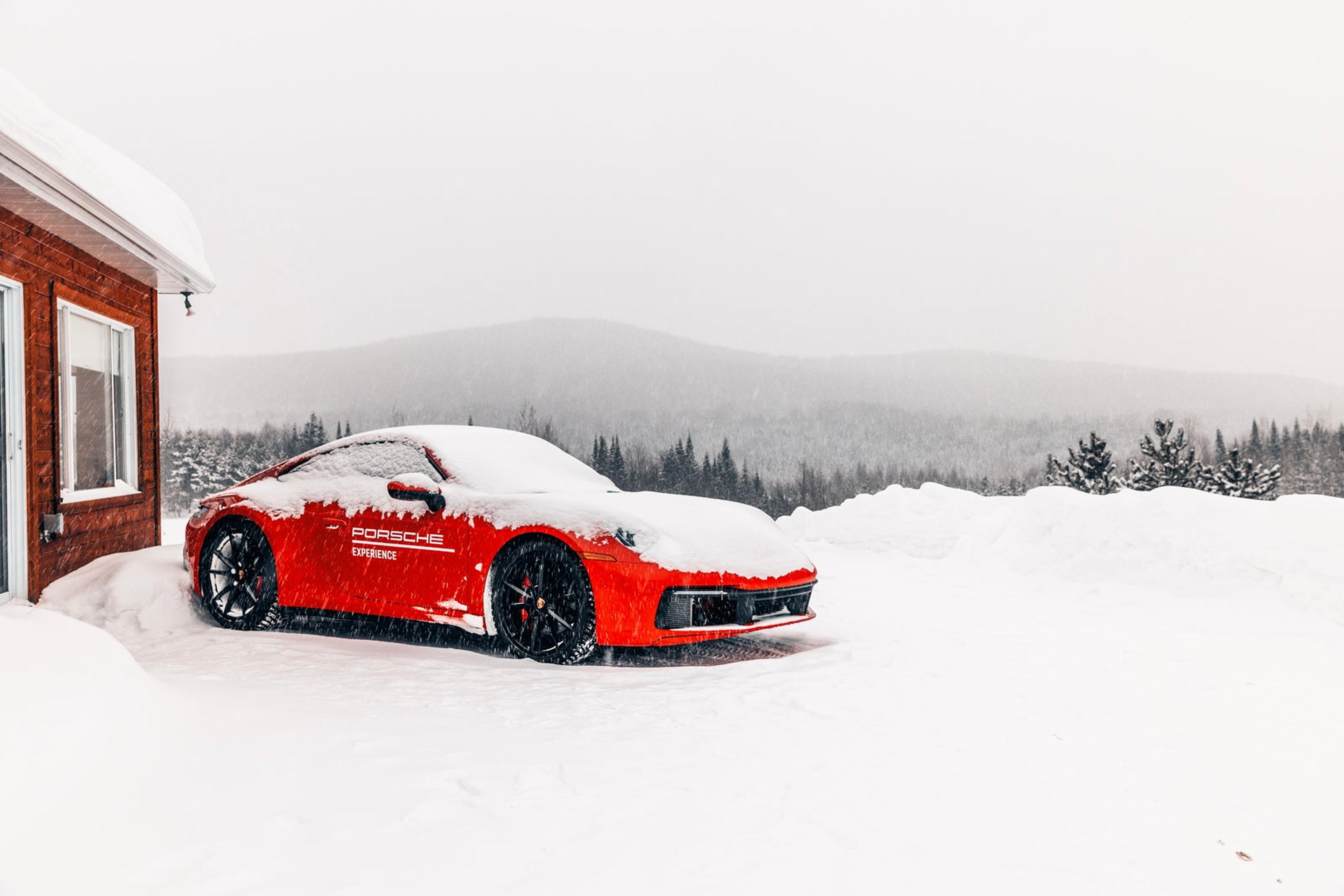 Red Porsche 911 driving on a snow-covered ice track in Canada