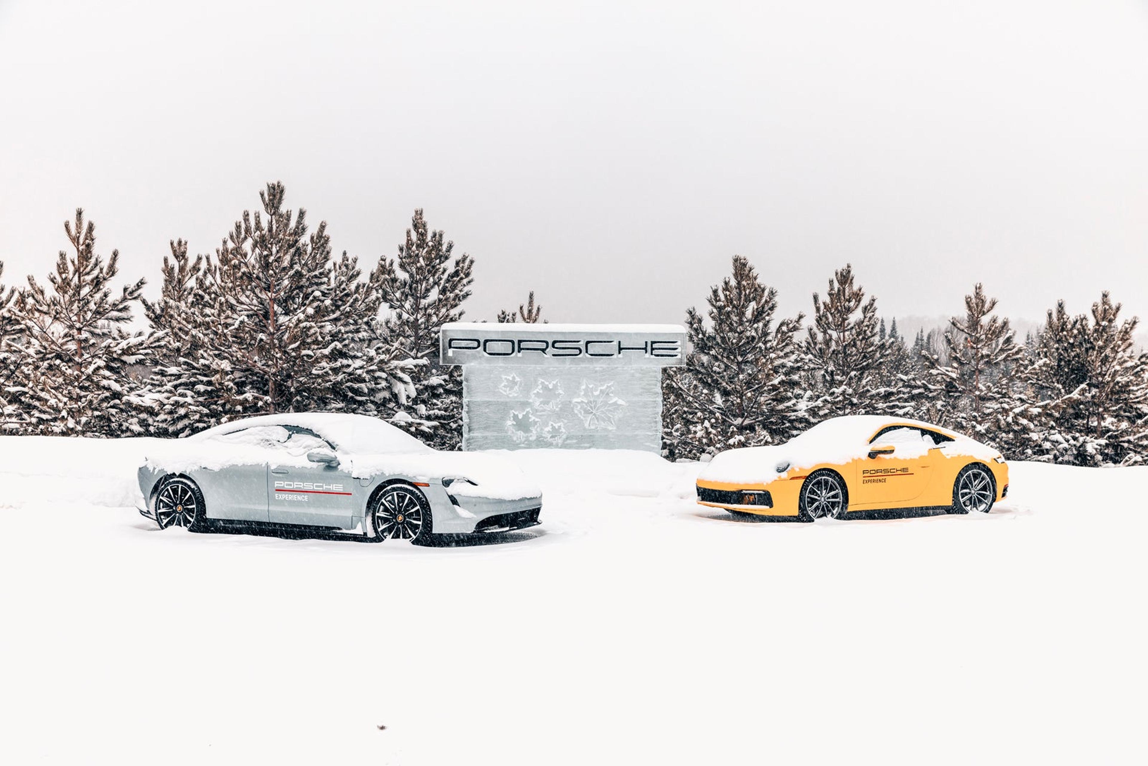 Porsche sports cars on a snowy ice track surrounded by pine trees