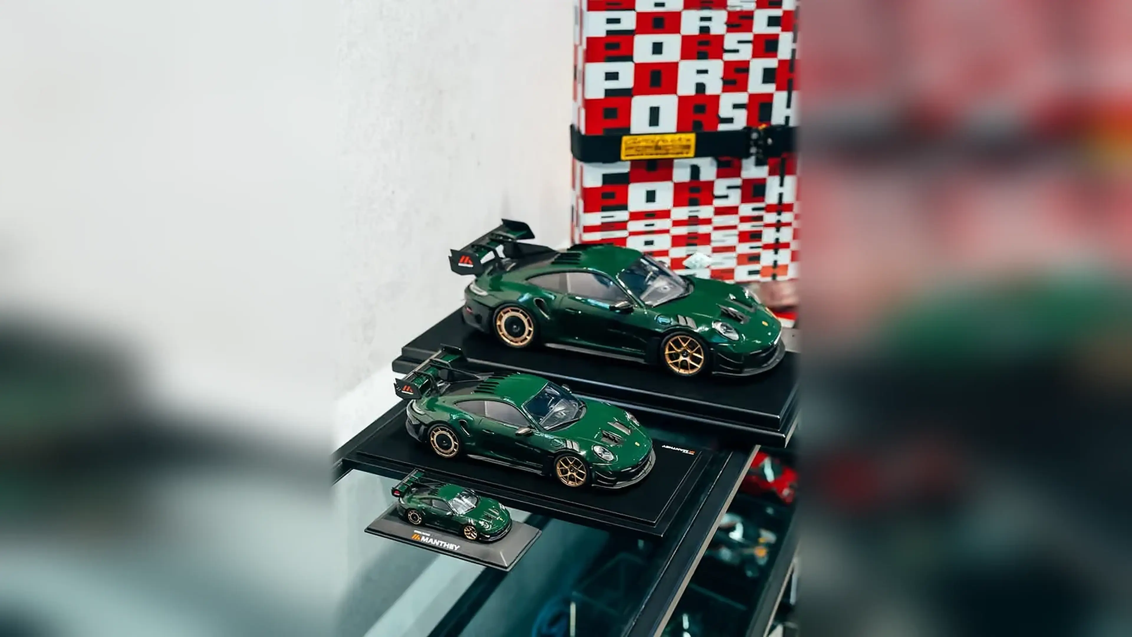 Green Porsche 911 Manthey scale models in three sizes.