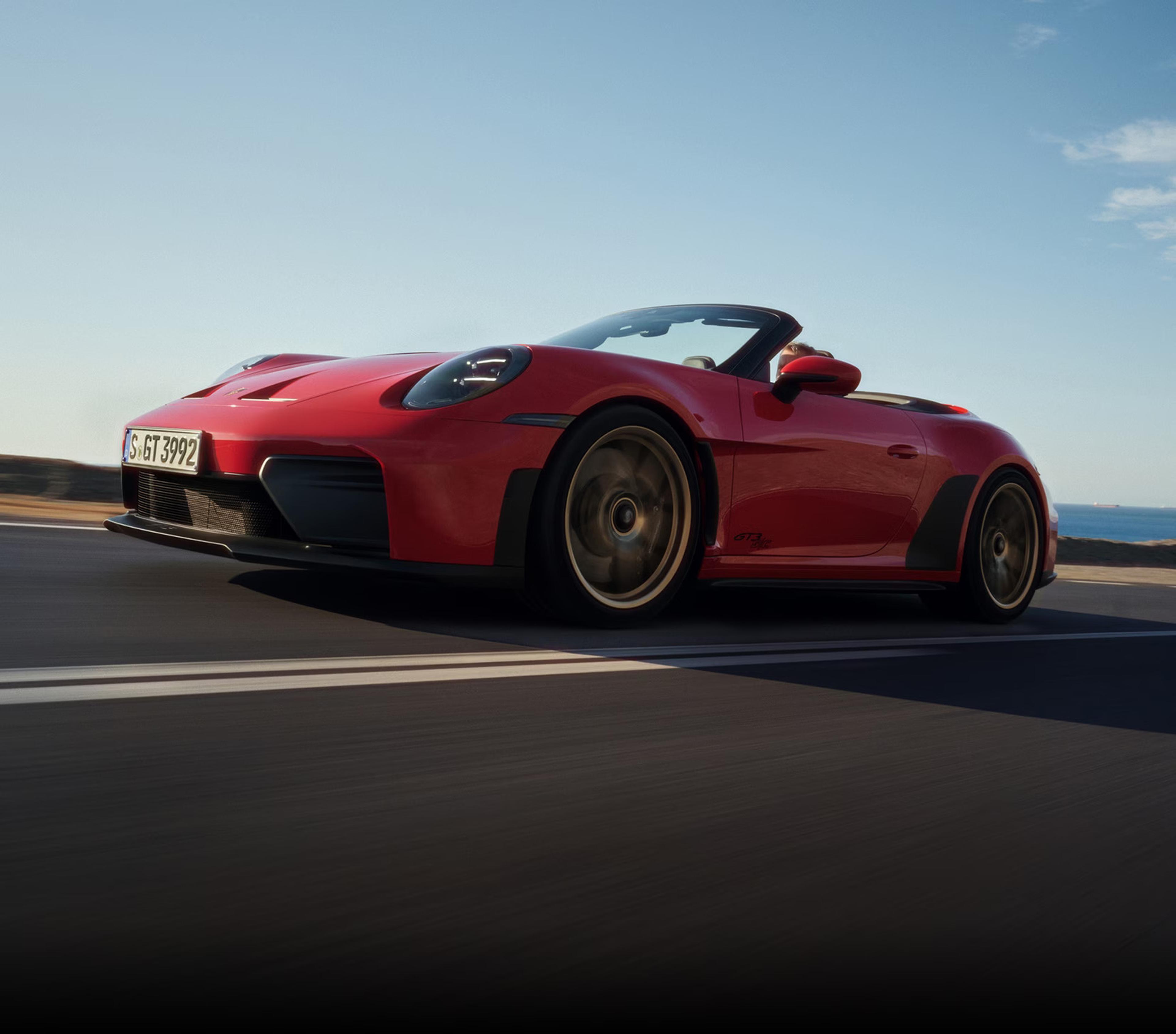 2027 Porsche 911 GT3 S/C open-air performance car driving with red exterior and sporty front design
