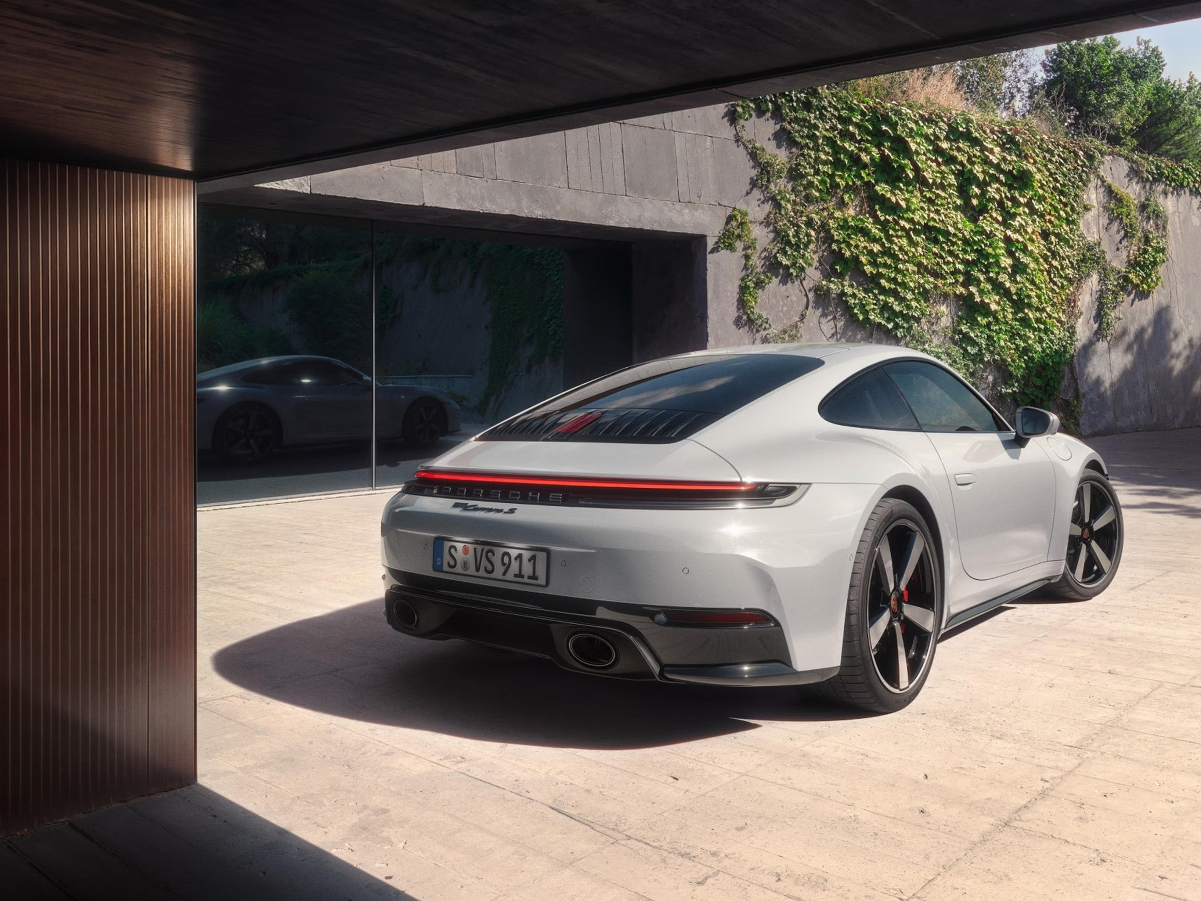 Rear three-quarter view of the white 2027 Porsche 911 Carrera S with MT Package
