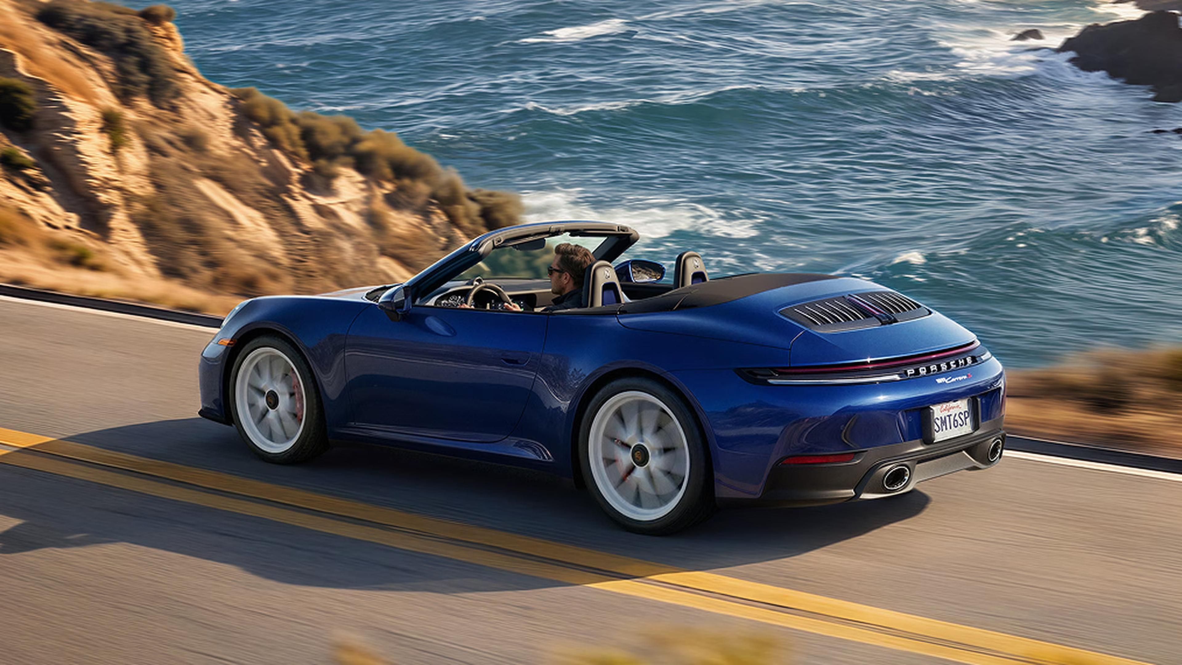 2027 Porsche 911 Carrera Cabriolet with MT Package driving on a coastal road