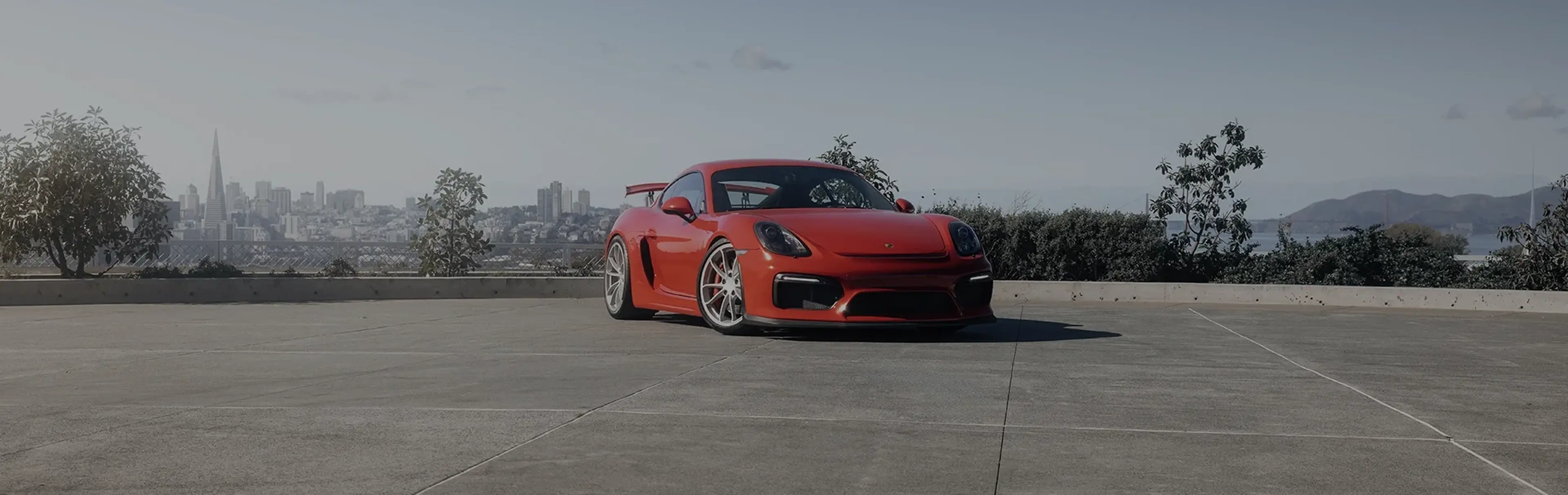 Red Porsche 718 Cayman parked outdoors