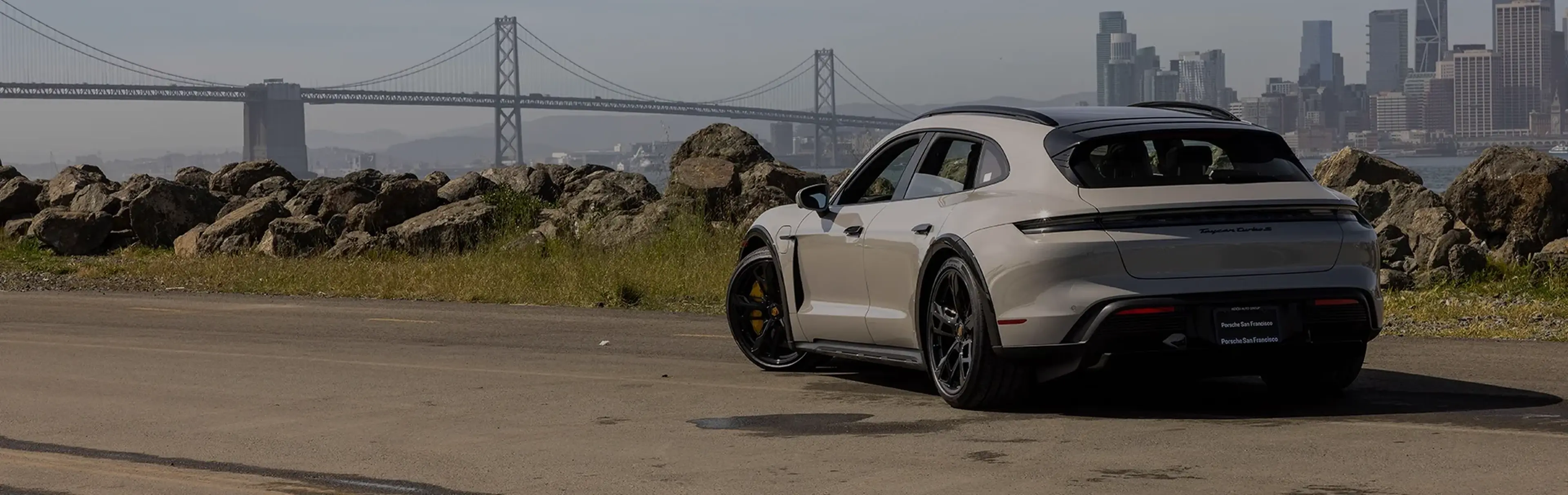 White Porsche Taycan parked near the Golden Gate Bridge in San Francisco
