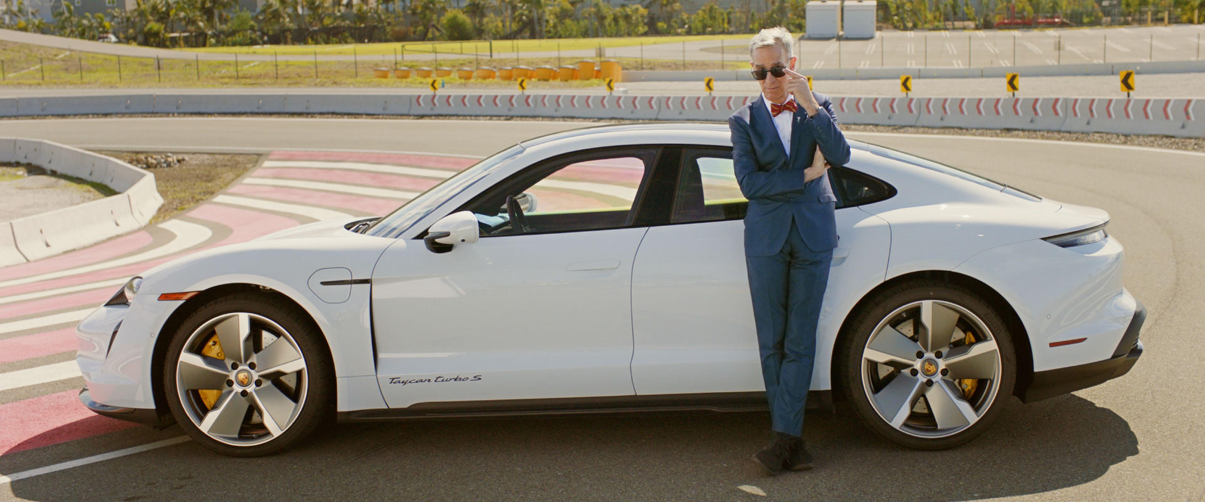 bill nye the science guy with a white porsche taycan 2021