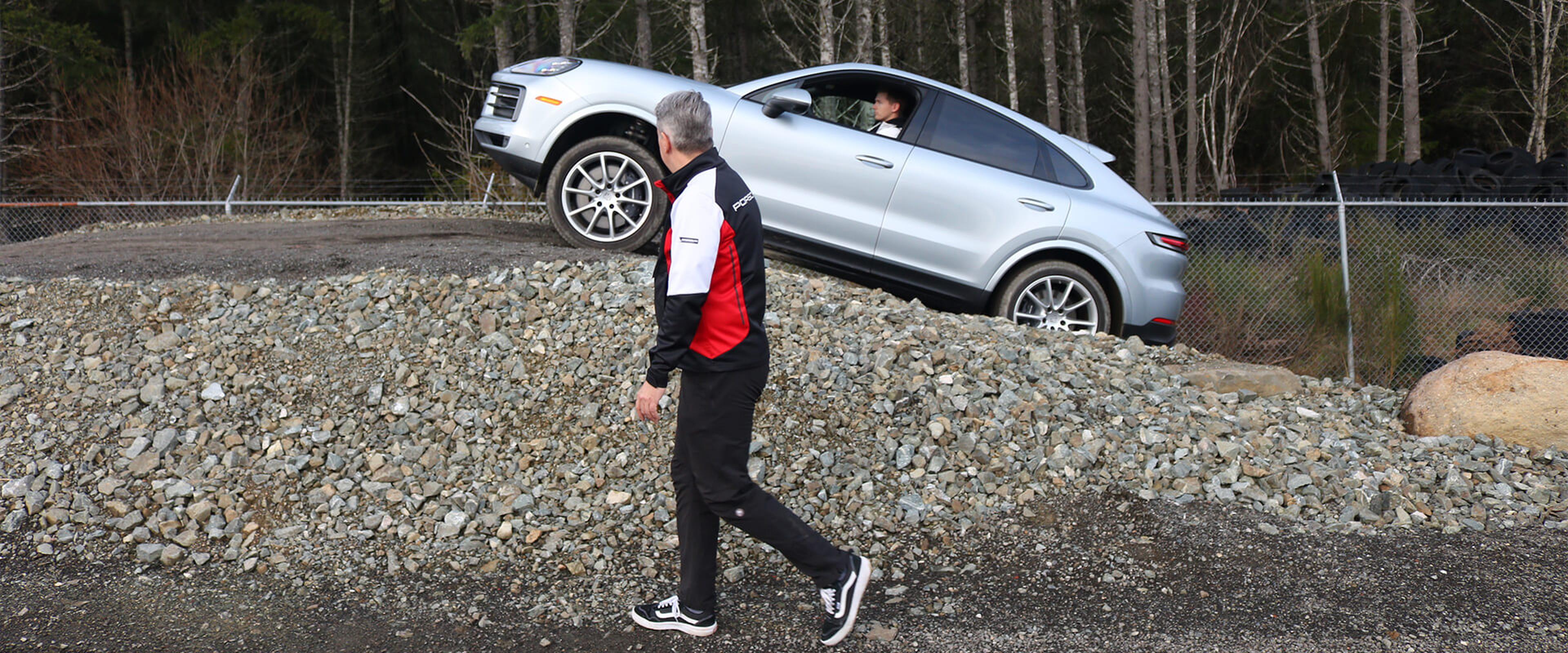 silver Porsche driving up steep incline