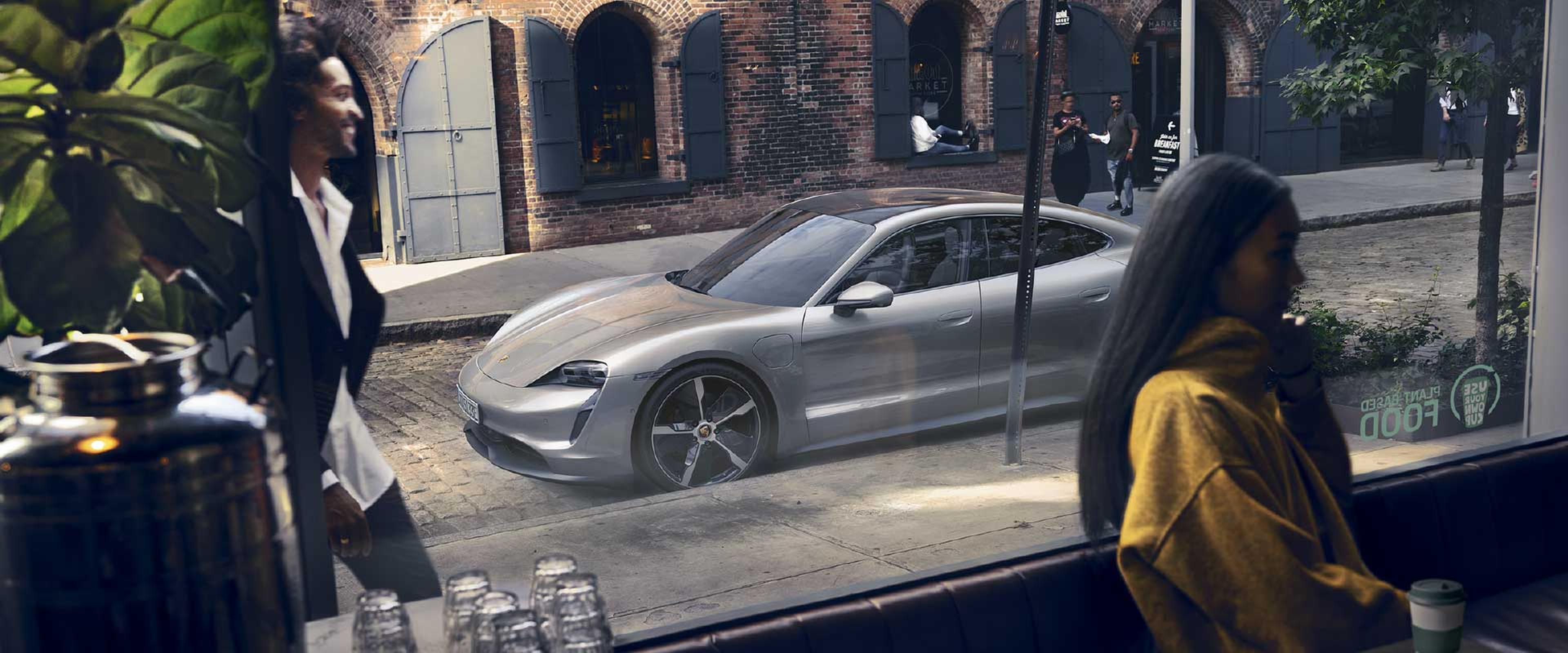 porsche silver taycan outside coffee shop