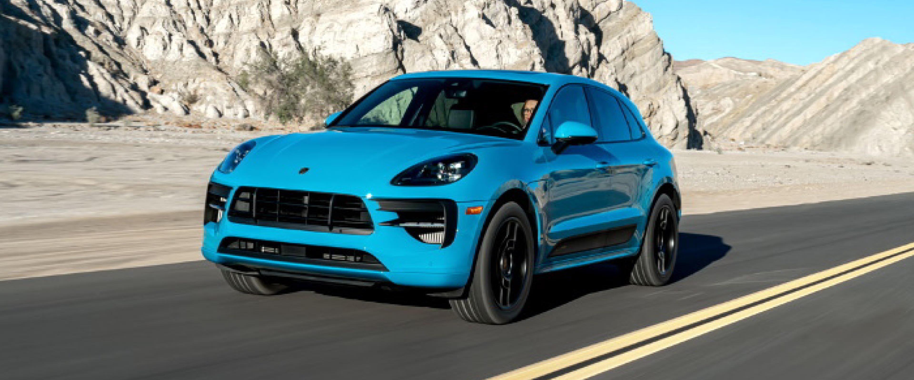 blue porsche macan suv on highway