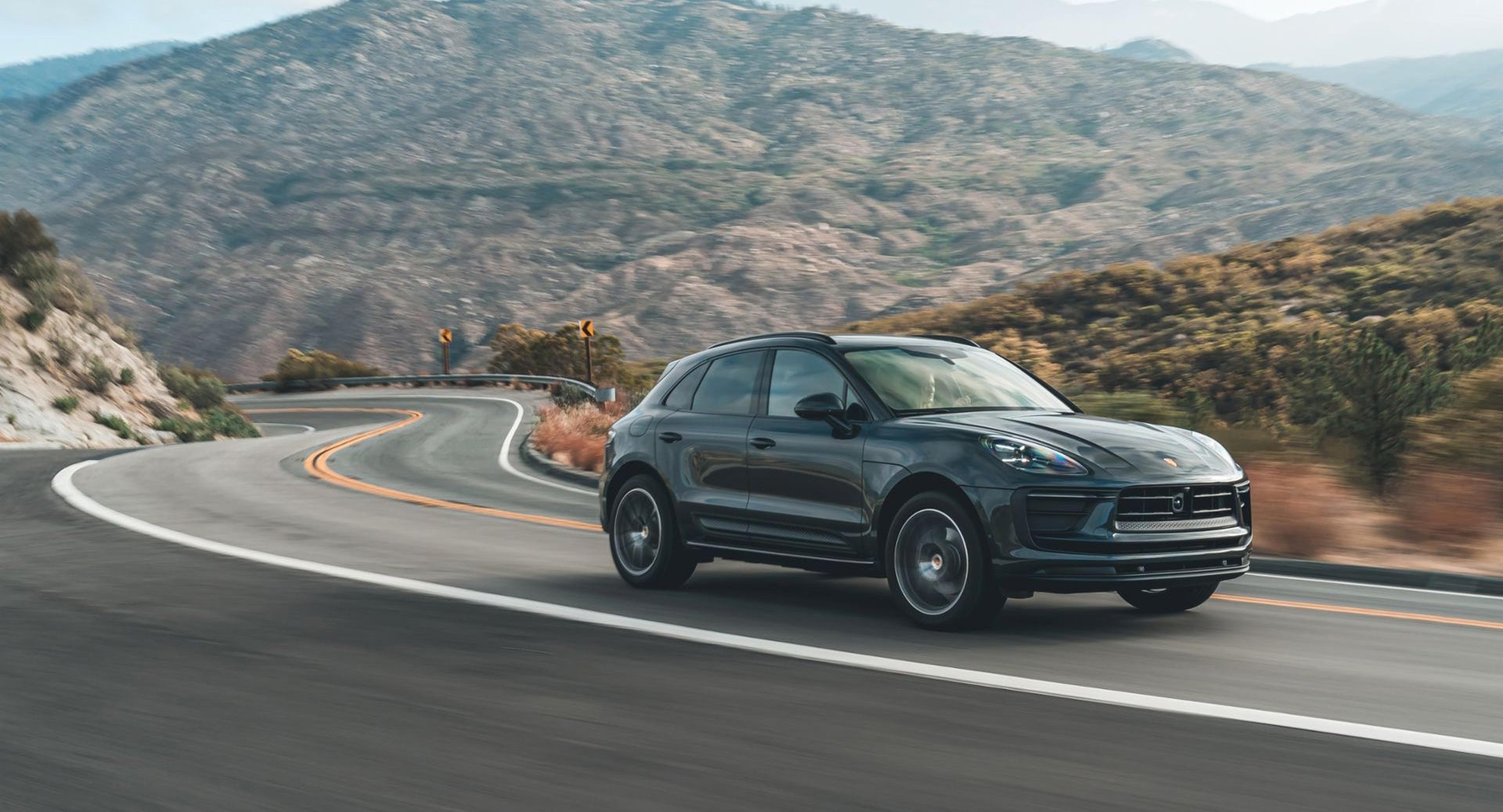 Volcano Grey Porsche Macan driving on a hillside road