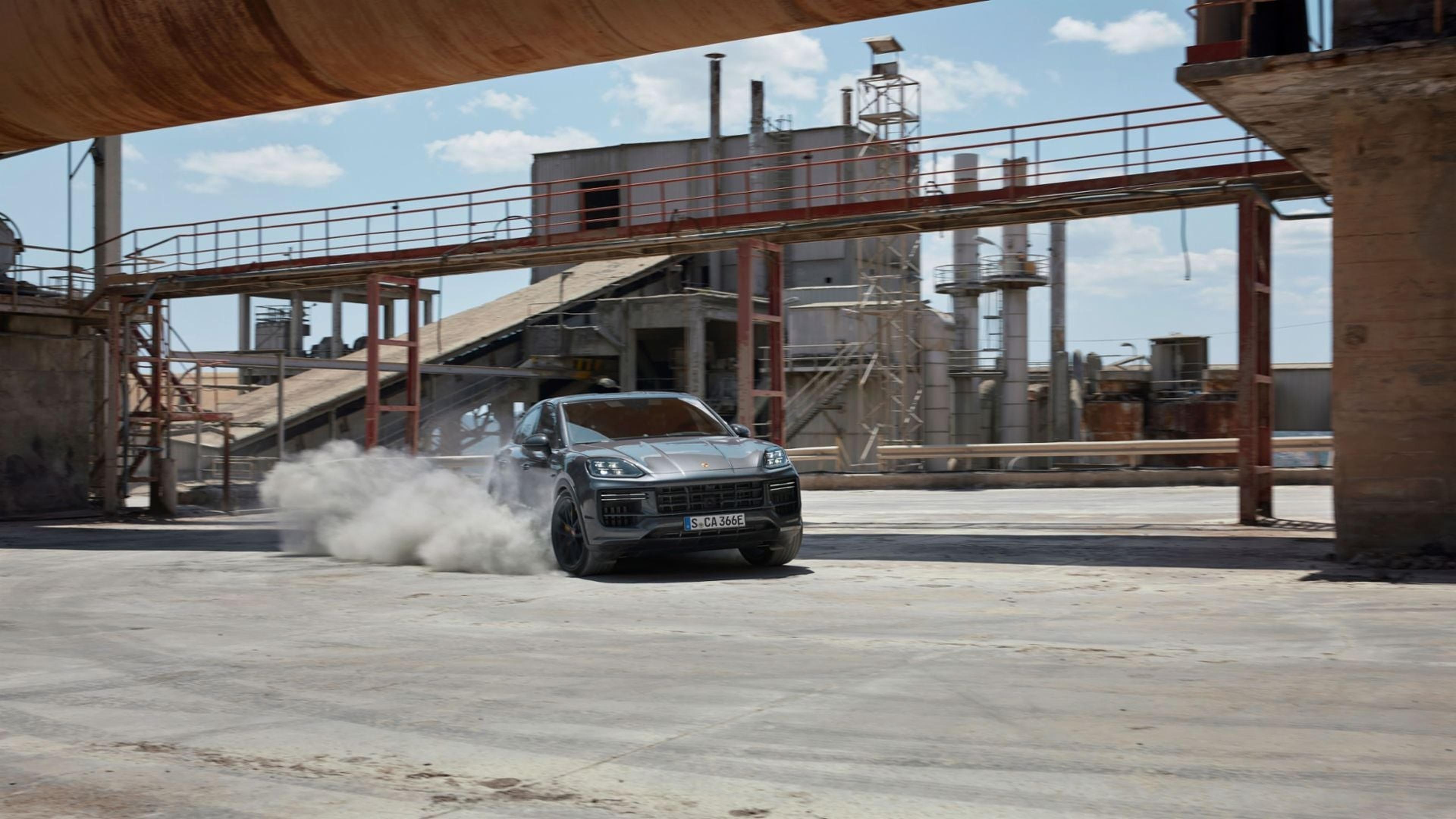 Porsche Cayenne Coupe drifting on a dusty lot
