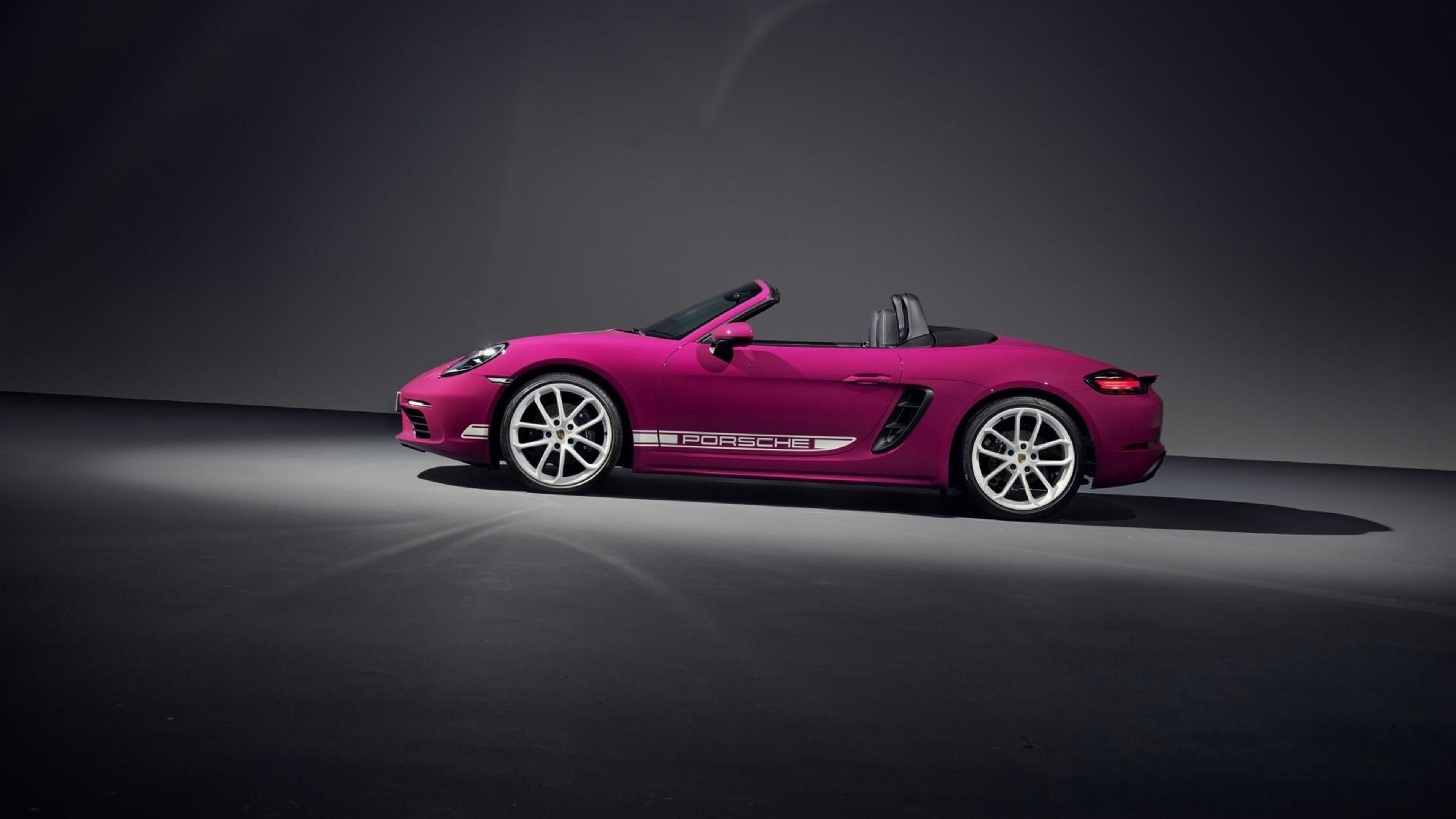 Magenta Porsche 718 Boxster with the top down