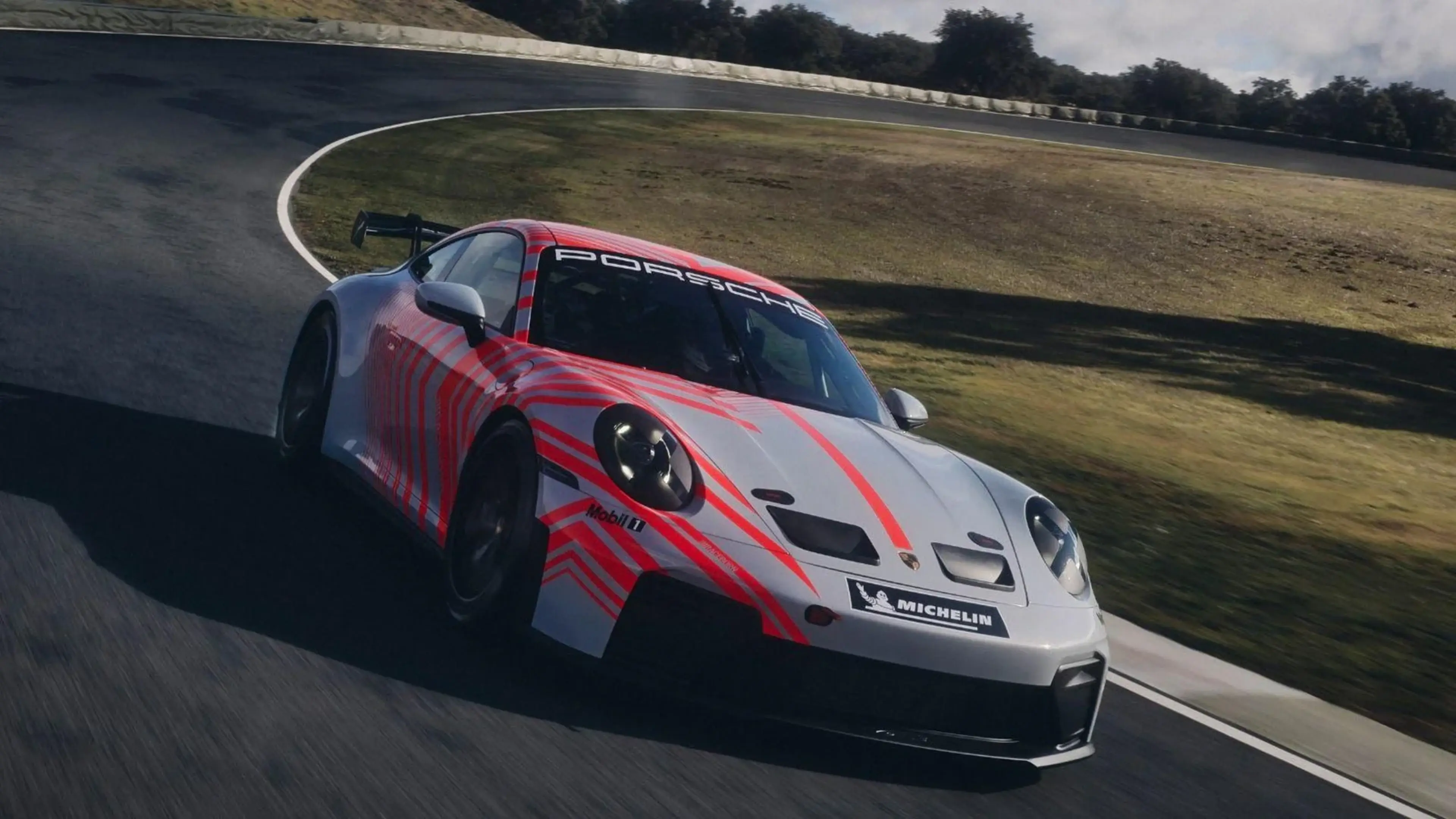 Porsche 911 GT3 Cup race car in pink and white livery
