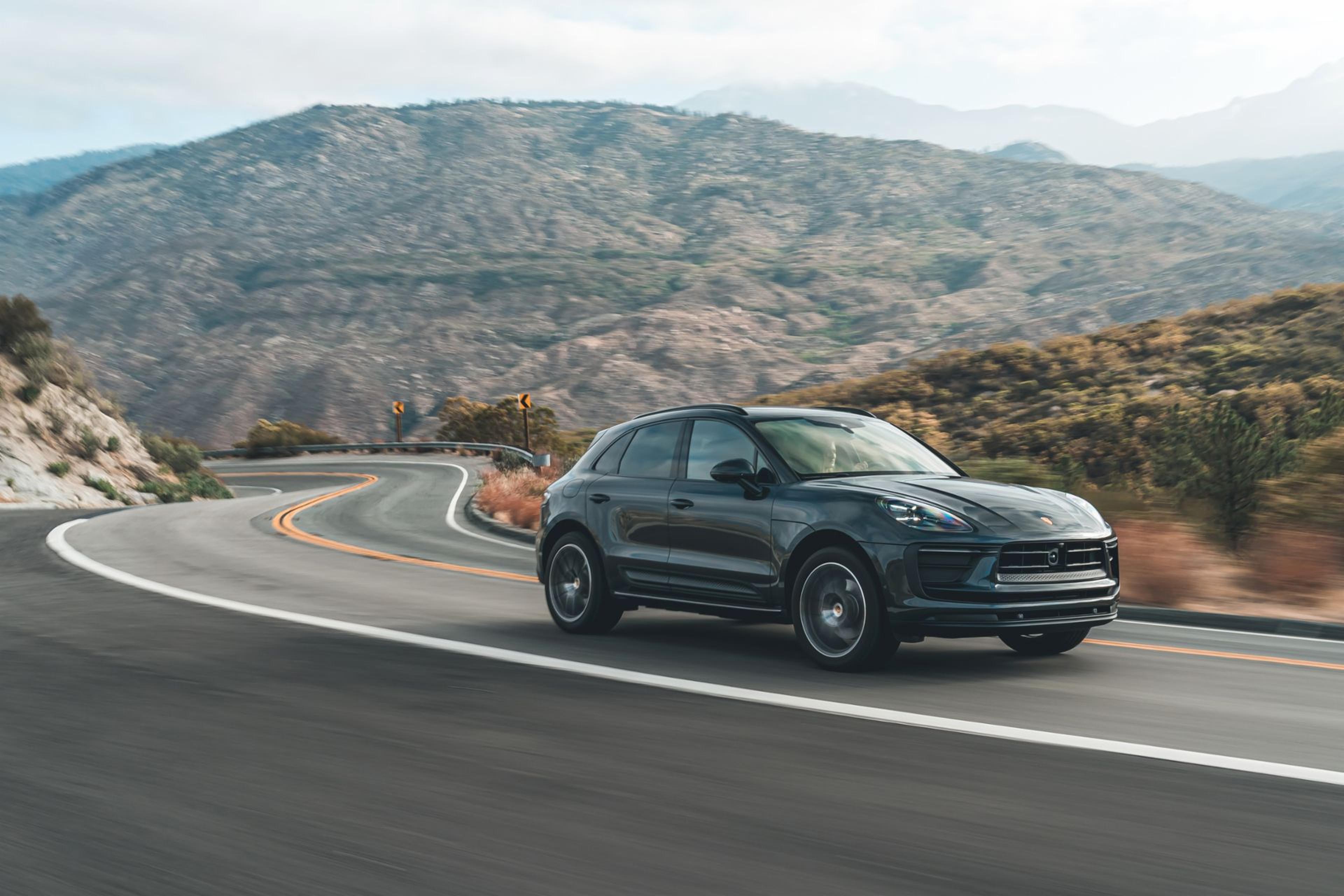 Porsche Macan driving through mountains