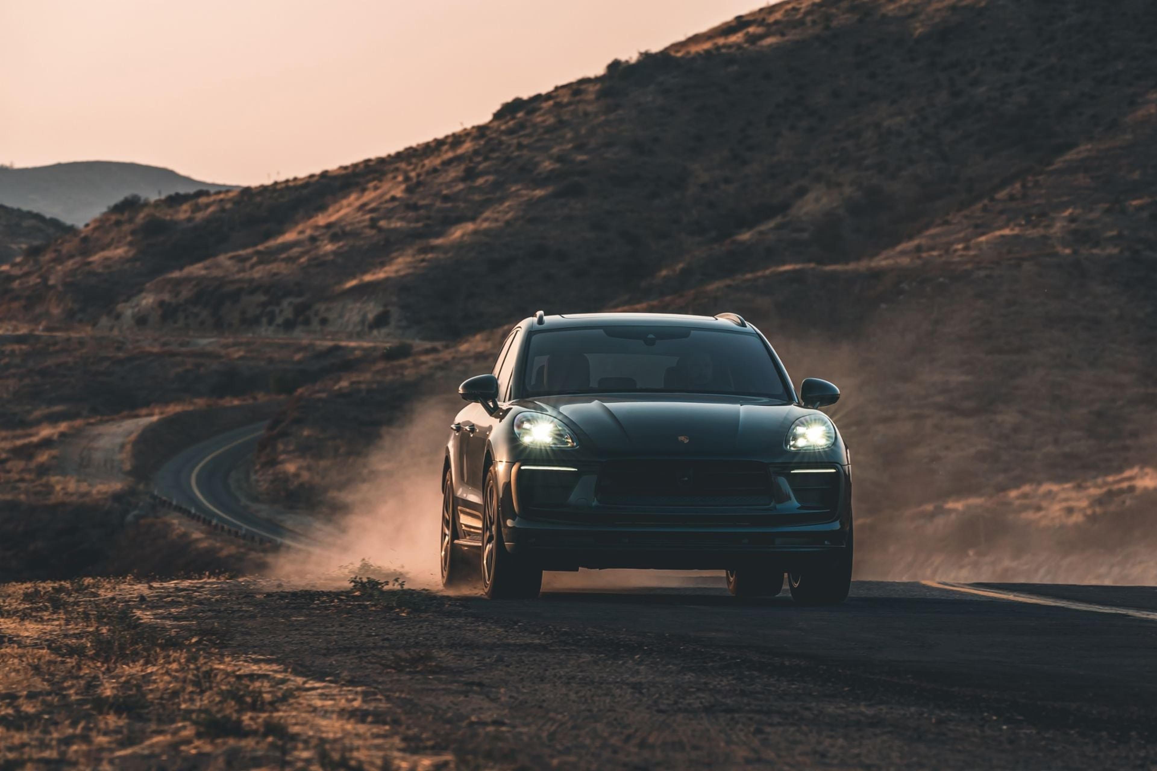 Porsche Macan headlights on a dusty road