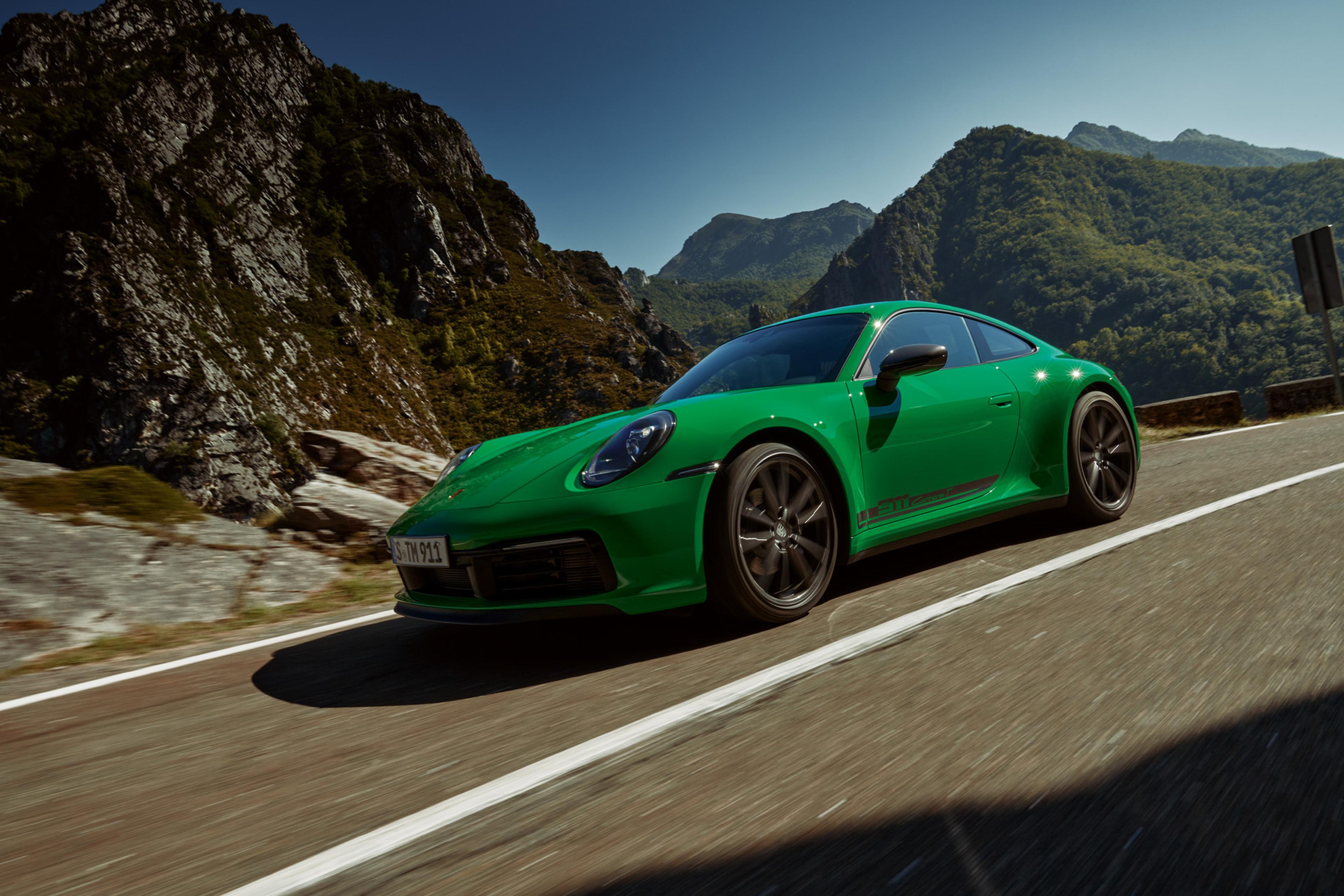 green 2027 Porsche Carrera driving in the mountains