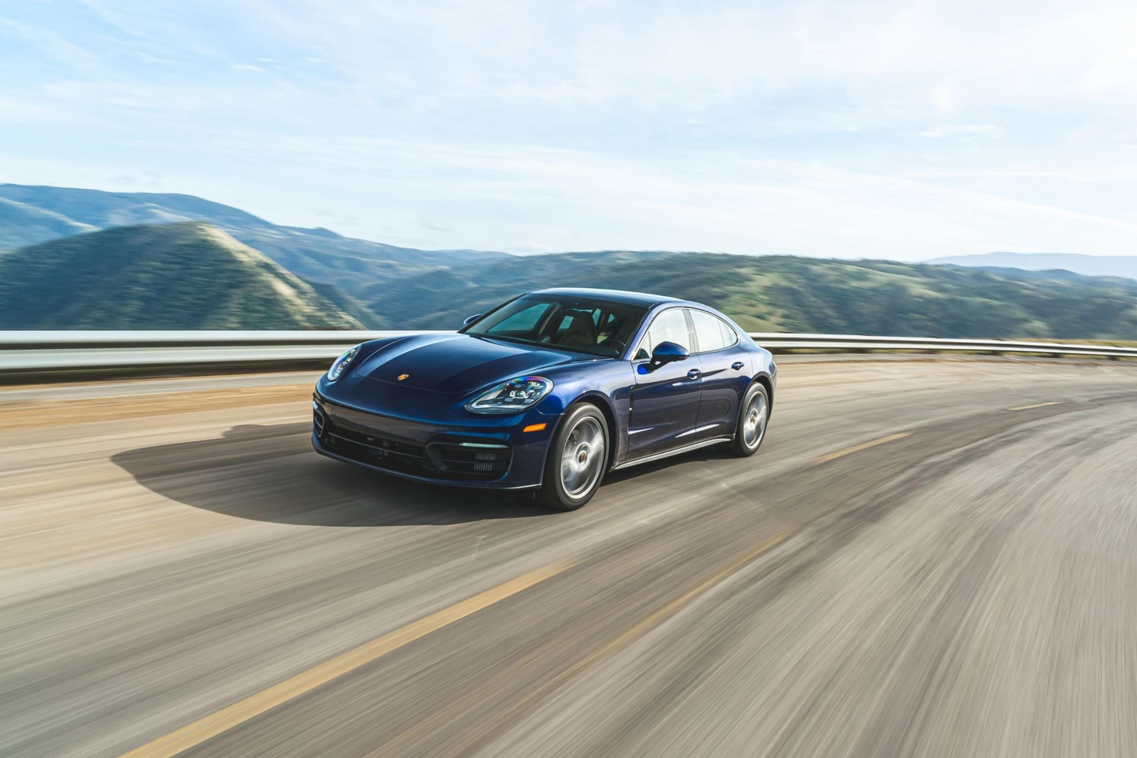 Blue Porsche Panamera on a mountain highway