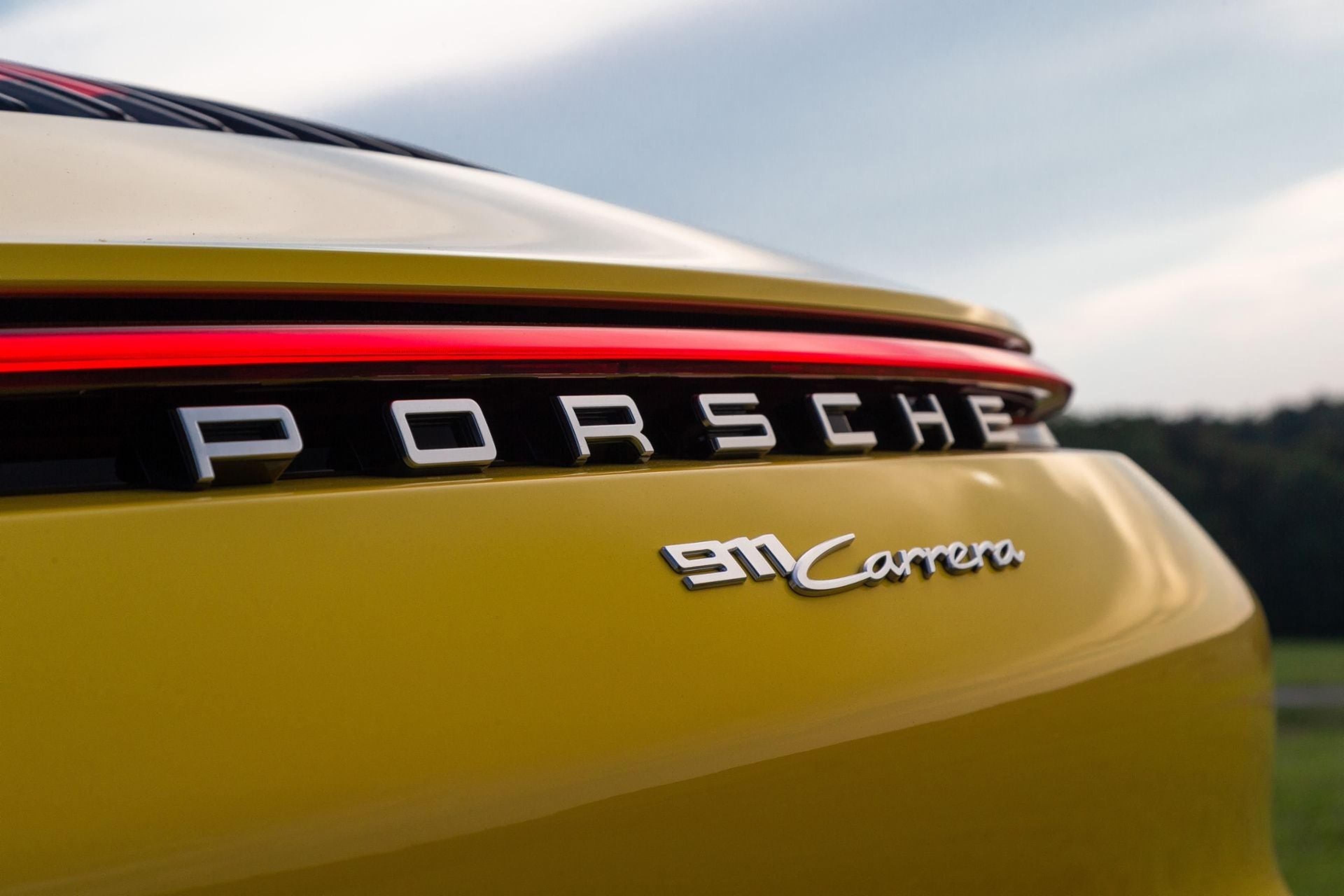 911 Carrera badge on a gold Porsche 911