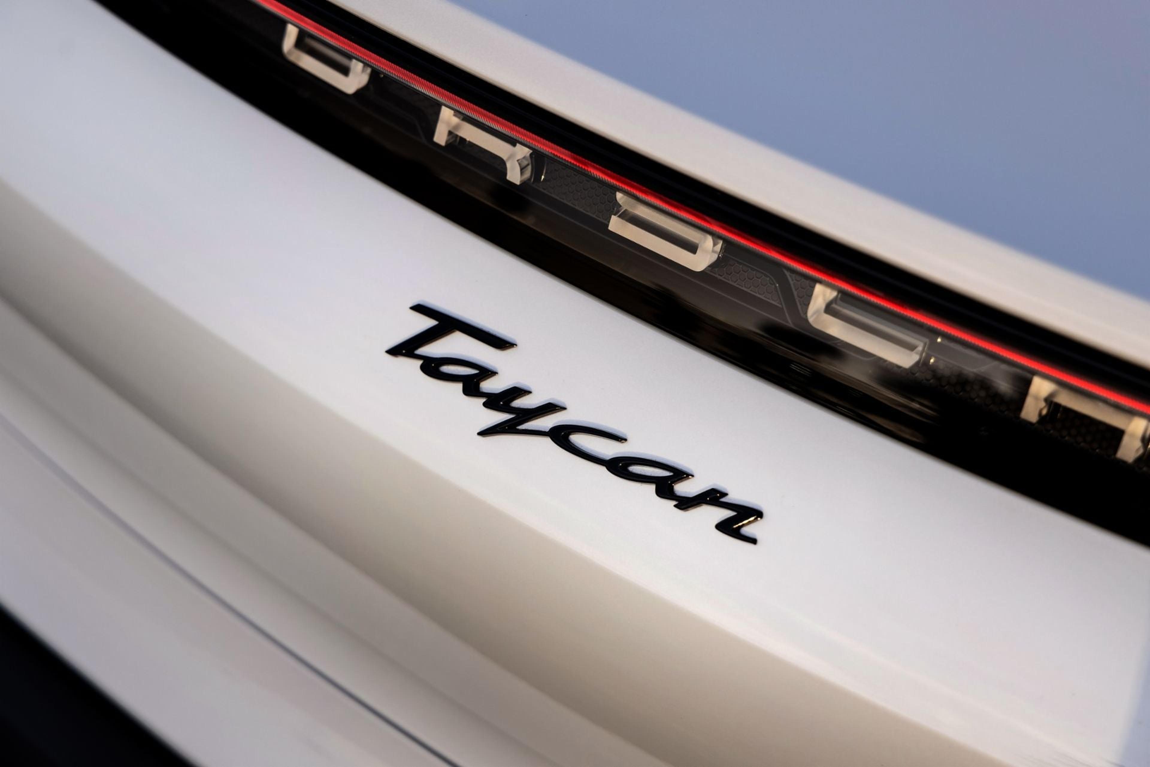 Taycan badge on a white Porsche Taycan
