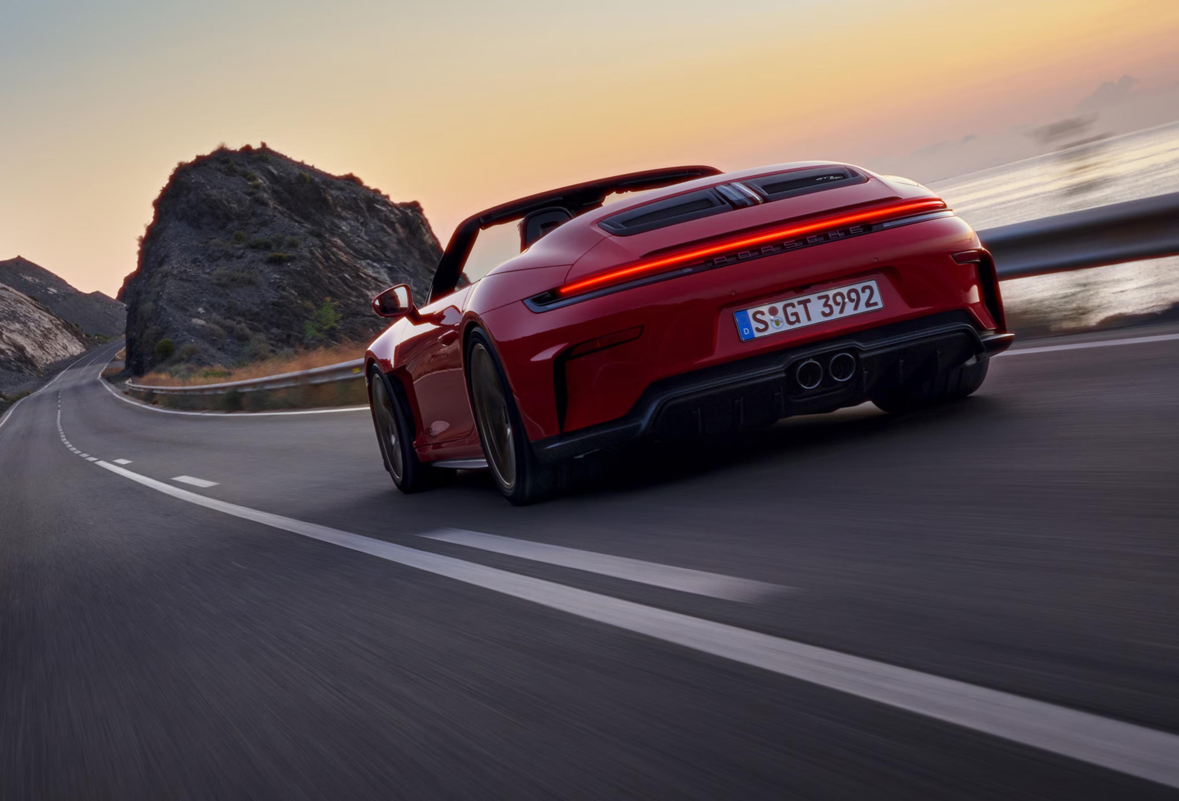 2027 Porsche 911 GT3 S/C rear view driving on a coastal road with open-air performance styling