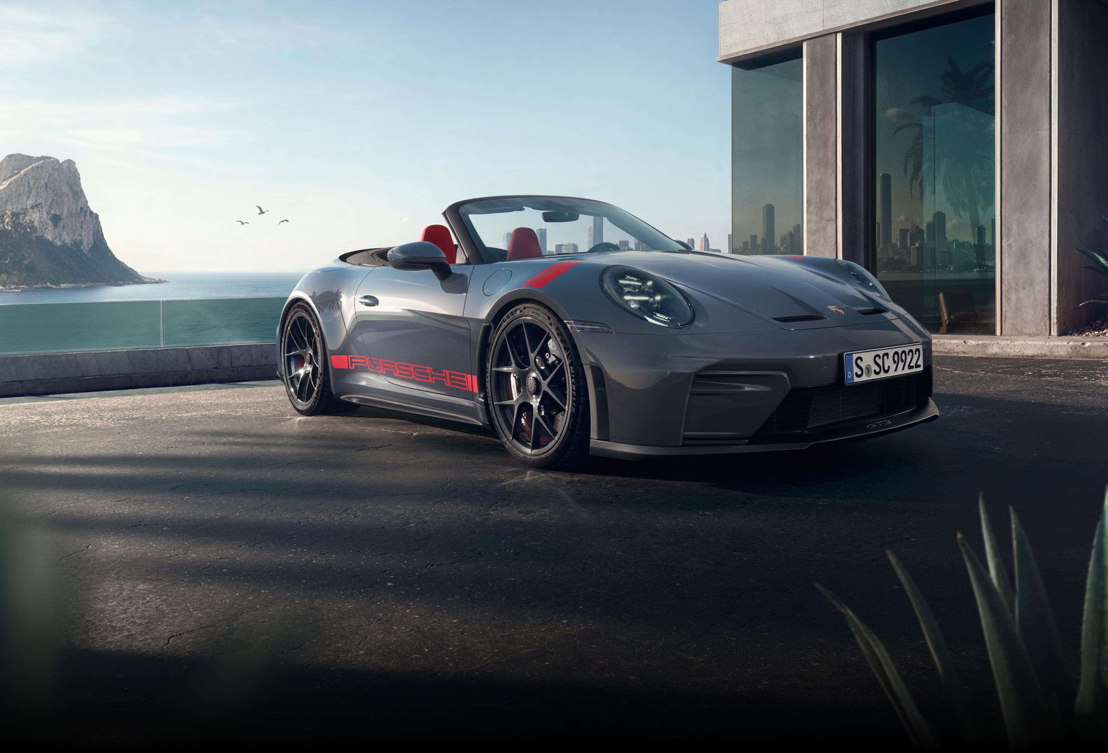 2027 Porsche 911 GT3 S/C open-air performance model in gray parked near a modern coastal building