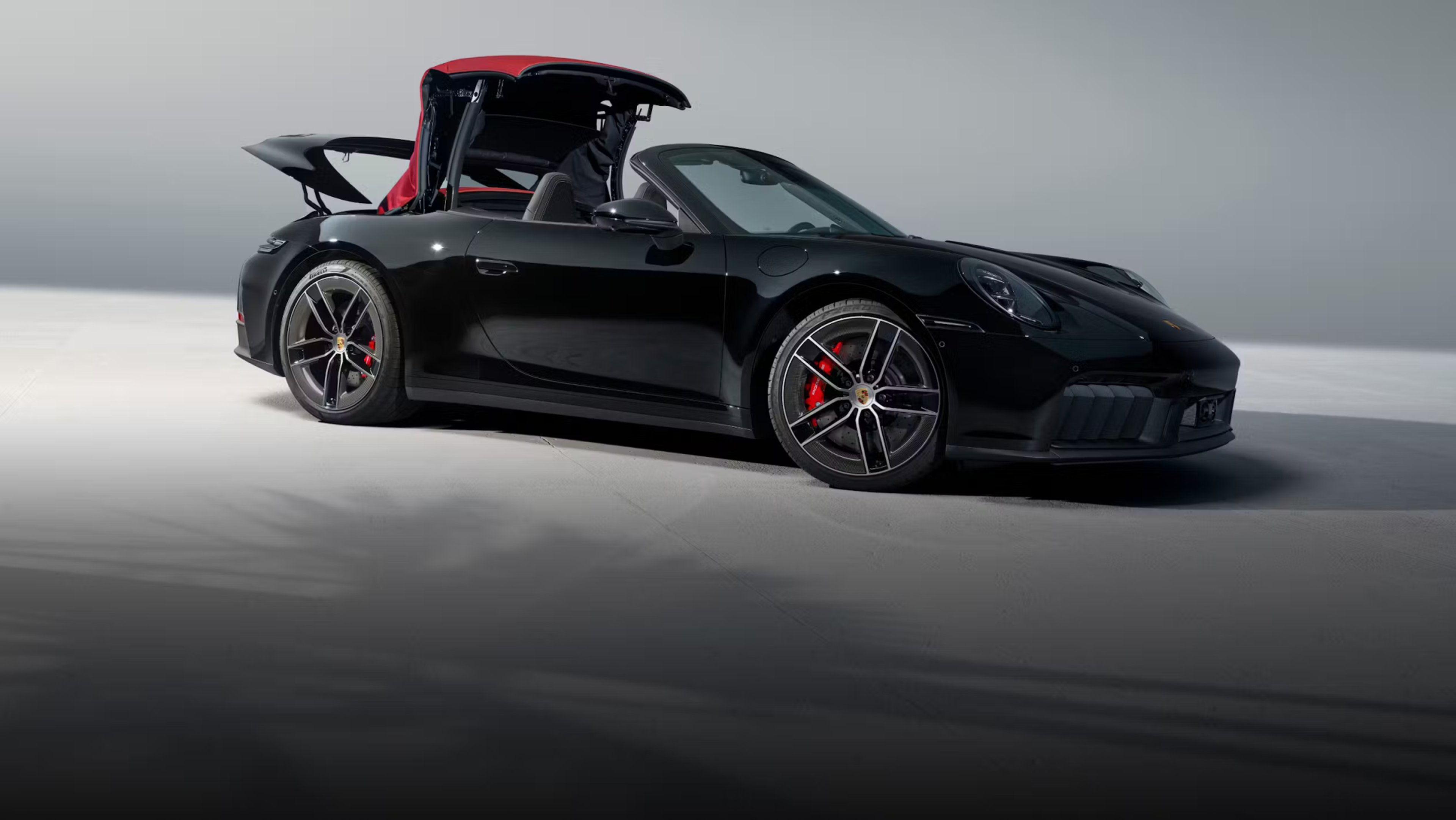 Black Porsche 911 convertible shown in profile, highlighting why the Porsche 911 still defines the modern sports car.