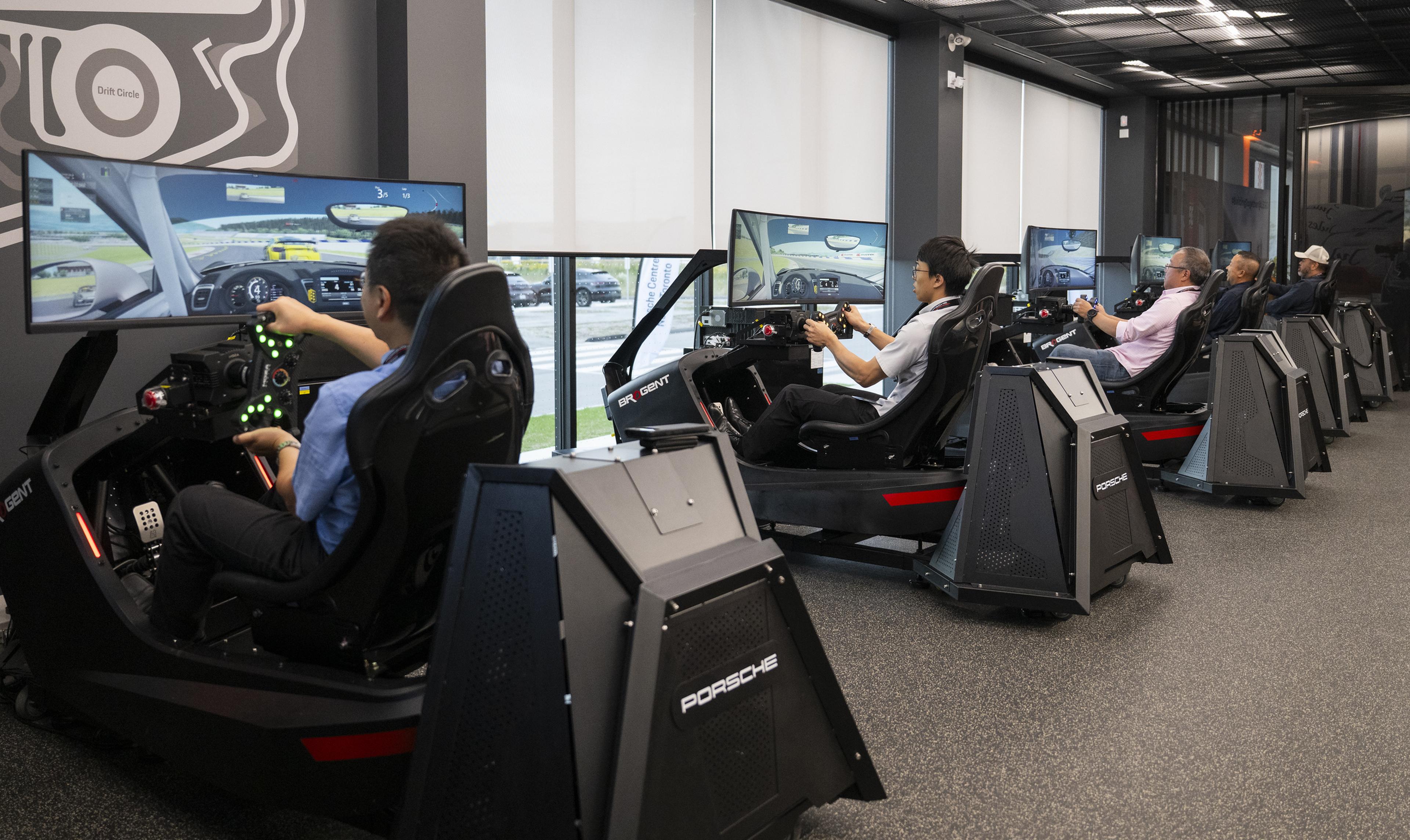Guests enjoyed the Simulator Lab racing each other during Porsche Centre North Toronto's 2026 Cayenne Electric Launch Experience Event.