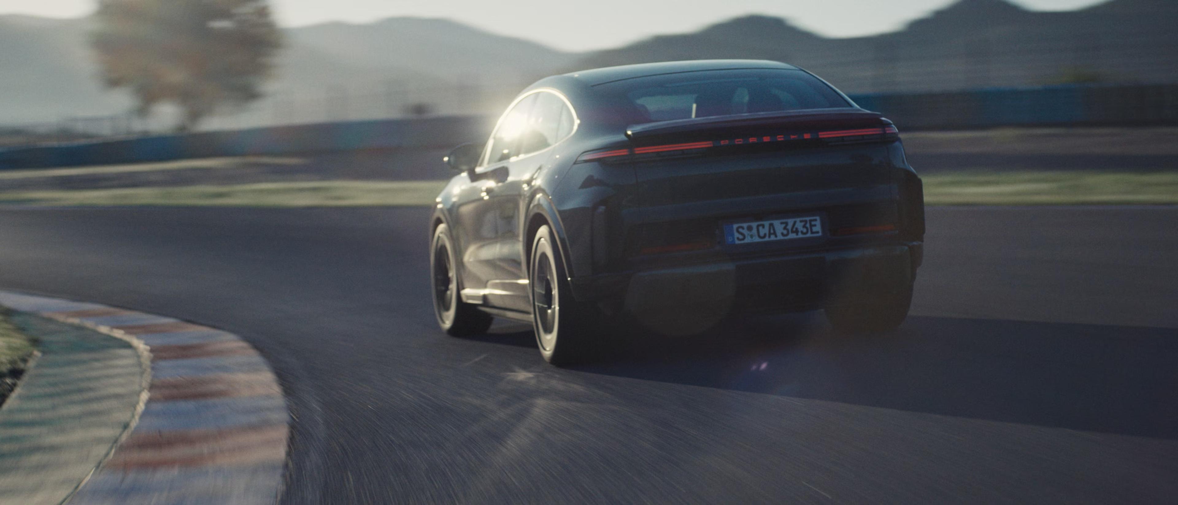 The 2027 Porsche Cayenne Coupe driving on a race track
