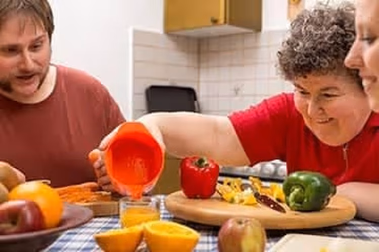 Three persons cooking together.