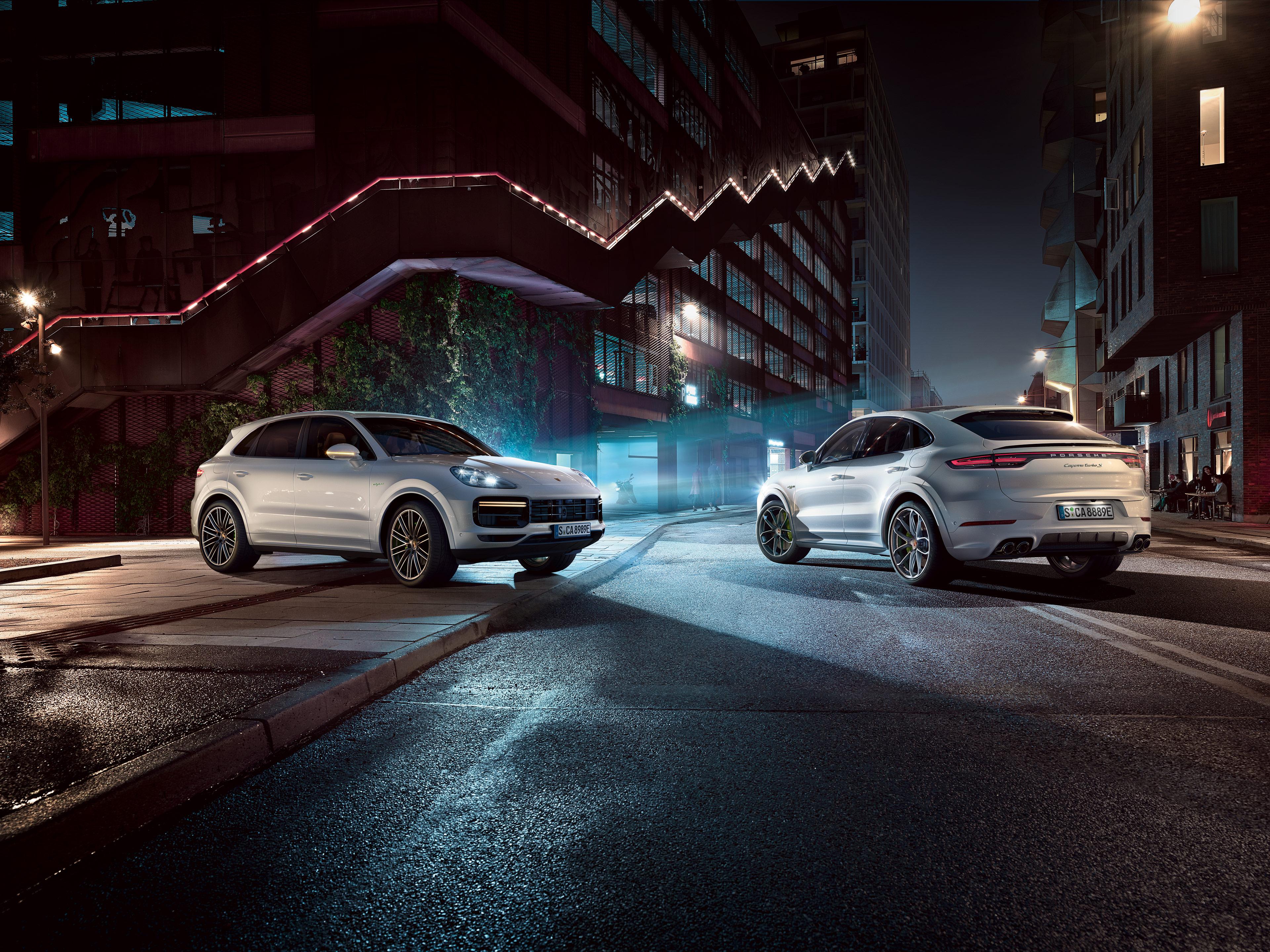 Two white Cayenne models