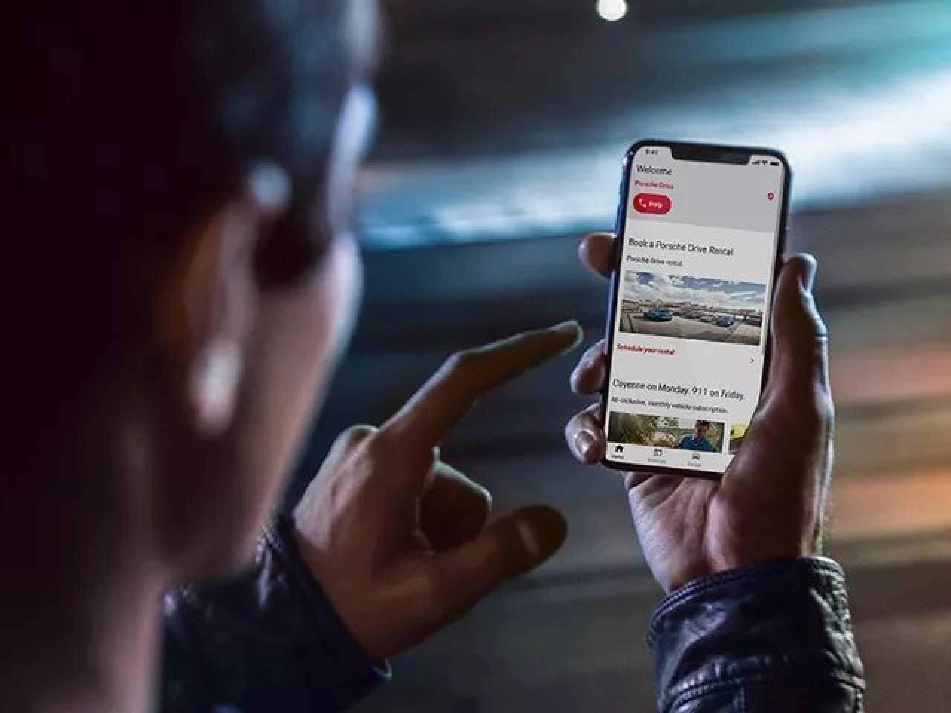 person using porsche drive on phone