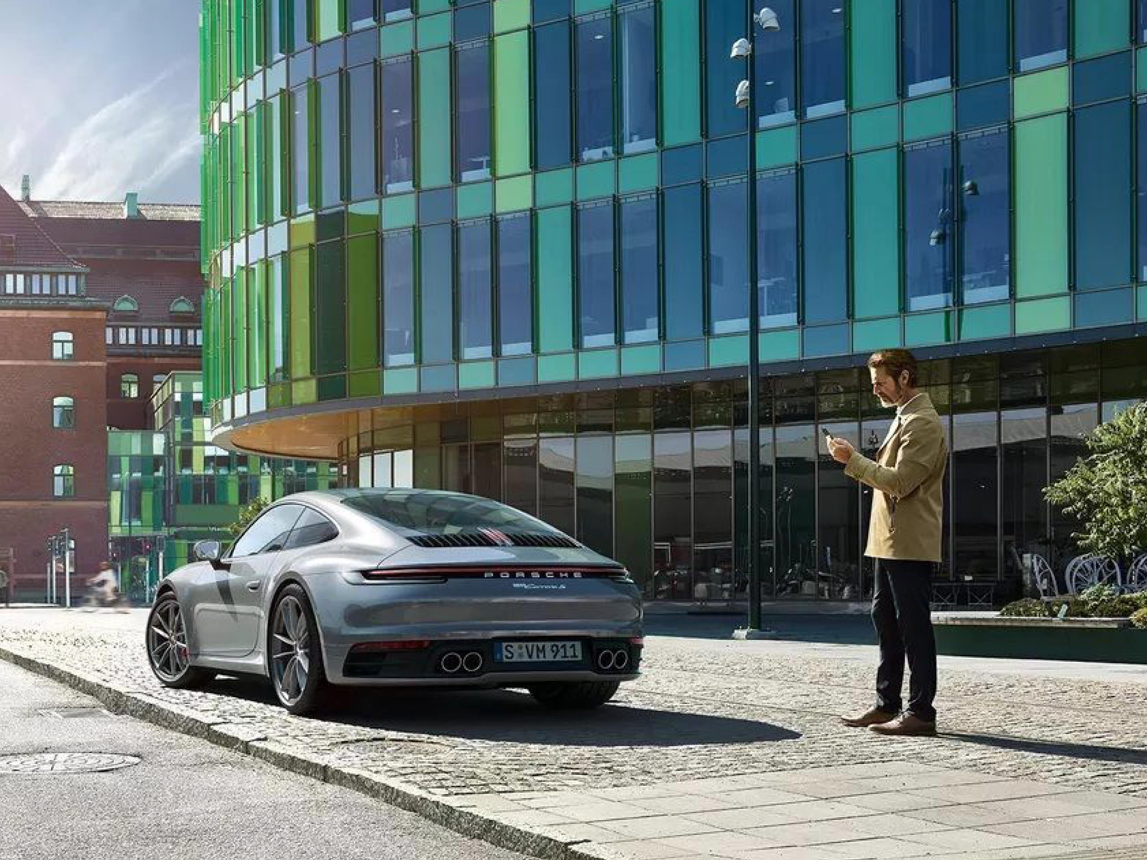 blue porsche and a man using porsche drive