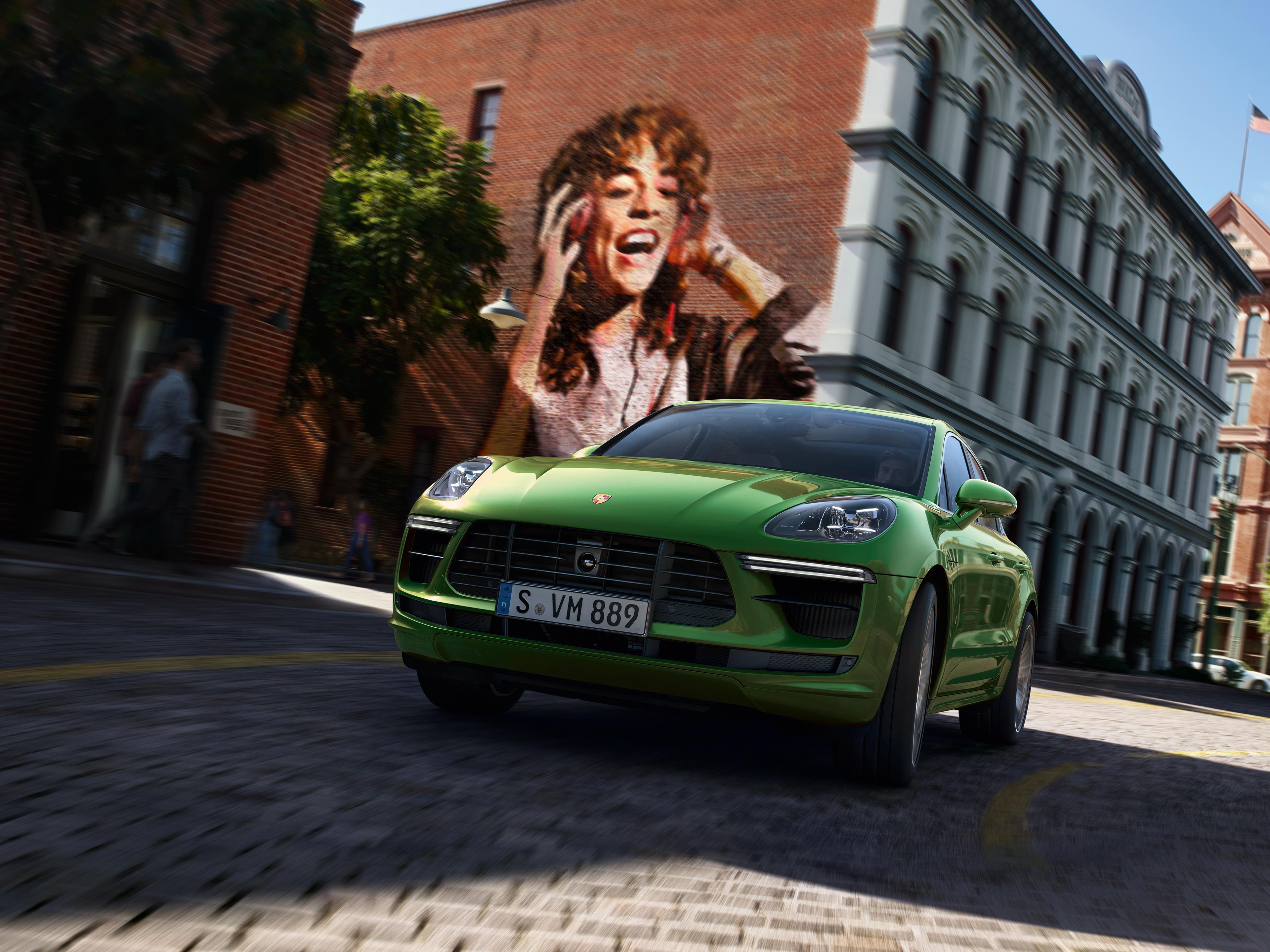 Green Macan GTS in a thrilling city