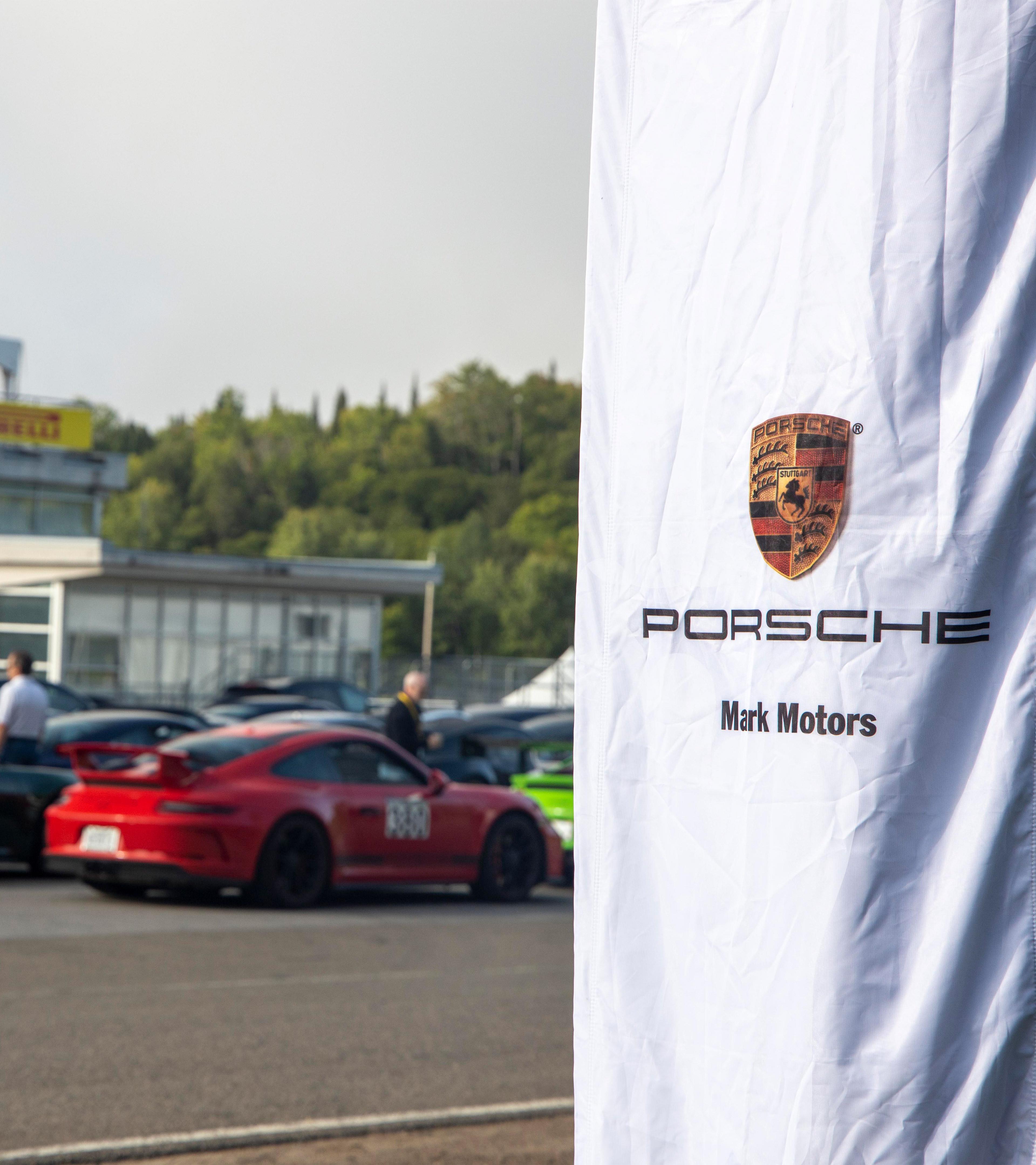 Mark Motors Porsche Flag with Porsche lineup in behind
